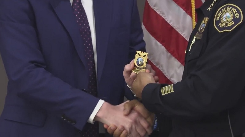 A new Portland Police Bureau officer receives his badge (PPB, file)