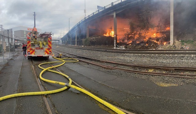 Fire burns homeless camp near Broadway Bridge, spread to nearby brush on Thursday, March 23, 2023