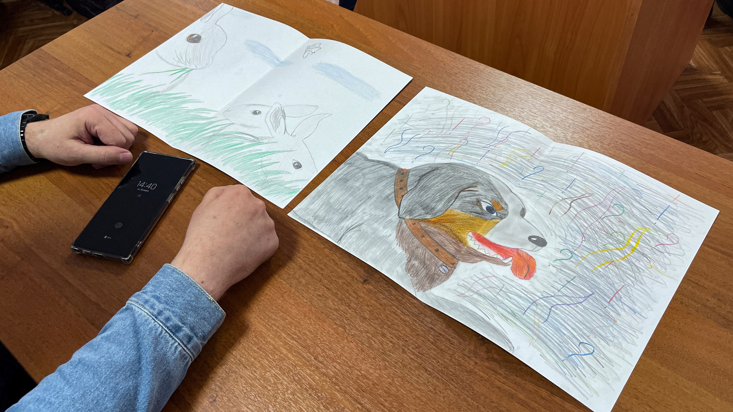 Moskalyov's lawyer Vladimir Biliyenko shows drawings that Maria Moskalyova, daughter of Alexei Moskalyov, drew for her father in a courtroom in Yefremov, Tula region, some 300 kilometers (186 miles) south of Moscow, Russia, Monday, March 27, 2023. A court in Russia on Tuesday convicted a single father over social media posts criticizing the war in Ukraine and sentenced him to two years in prison — a case brought to the attention of authorities by his daughter's drawings against the invasion at school, according to the man's lawyer and local activists. The 54-year-old Moskalyov, a single father of a 13-year-old daughter, was accused of repeatedly discrediting the Russian army, a criminal offense in accordance to a law Russian authorities adopted shortly after sending troops into Ukraine. (AP Photo)