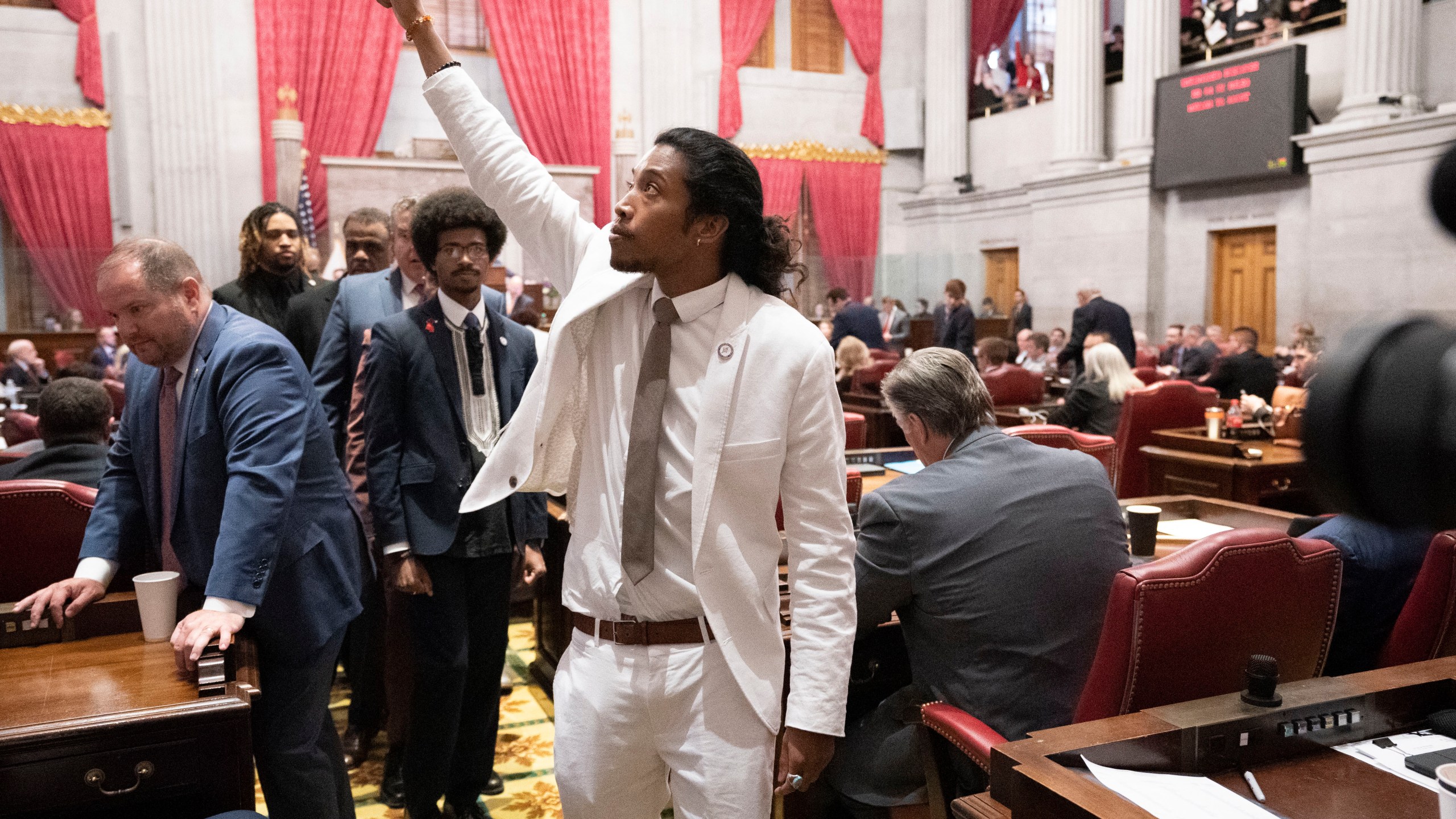 Former Rep. Justin Jones, D-Nashville, raises his fist on the floor of the House chamber as he walks to his desk to collect his belongings after being expelled from the legislature on Thursday, April 6, 2023, in Nashville, Tenn. Tennessee Republicans are seeking to oust three House Democrats including Jones for using a bullhorn to shout support for pro-gun control protesters in the House chamber. (AP Photo/George Walker IV)