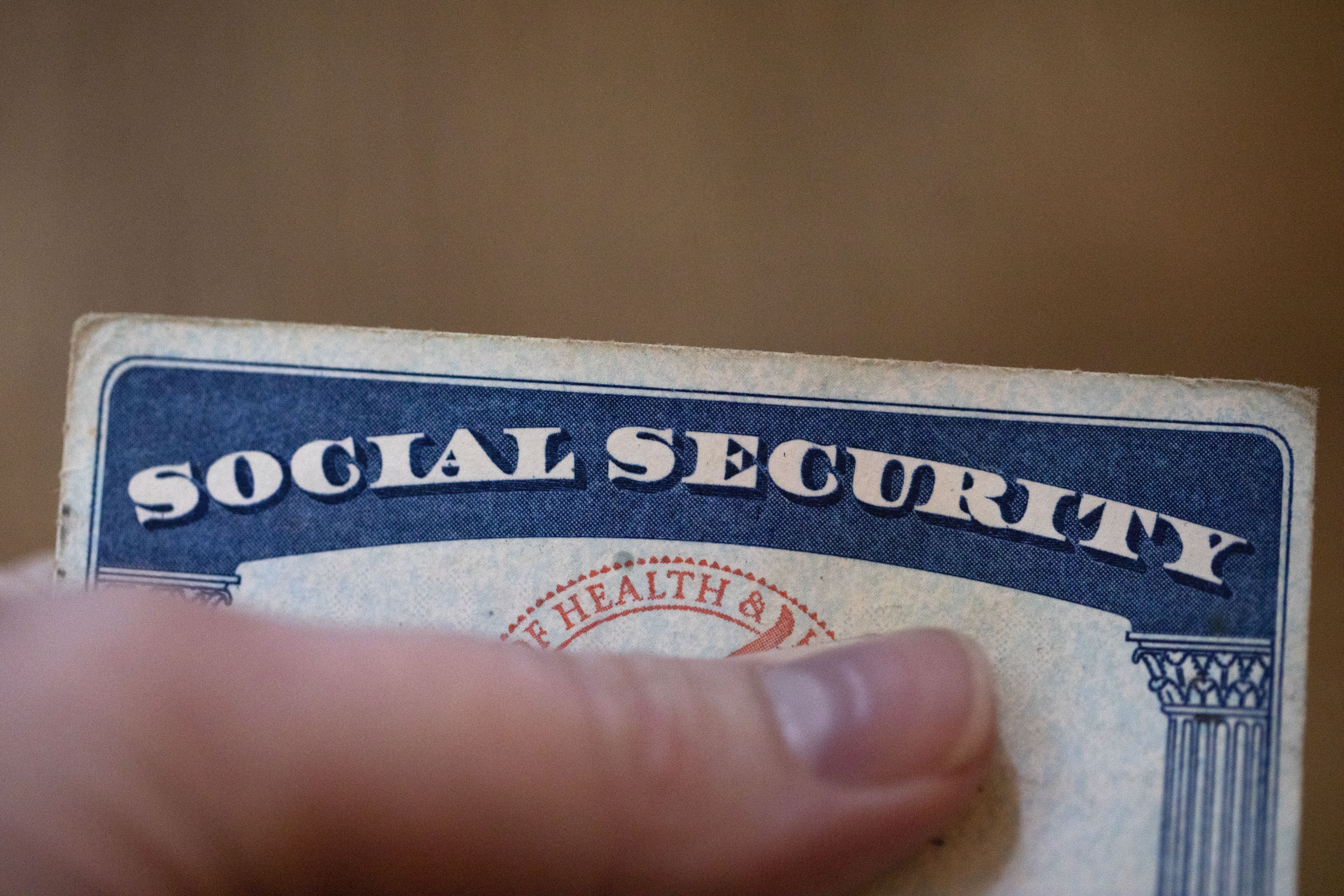 FILE - A Social Security card is displayed on Oct. 12, 2021, in Tigard, Ore. Most U.S. adults are opposed to proposals that would cut into Medicare or Social Security benefits, and a majority support raising taxes on the nation's highest earners to keep Medicare running as is. The new findings, revealed in a March poll by The Associated Press-NORC Center for Public Affairs Research, come as both safety net programs are poised to run out of enough cash to pay out full benefits within the next decade. (AP Photo/Jenny Kane, File)