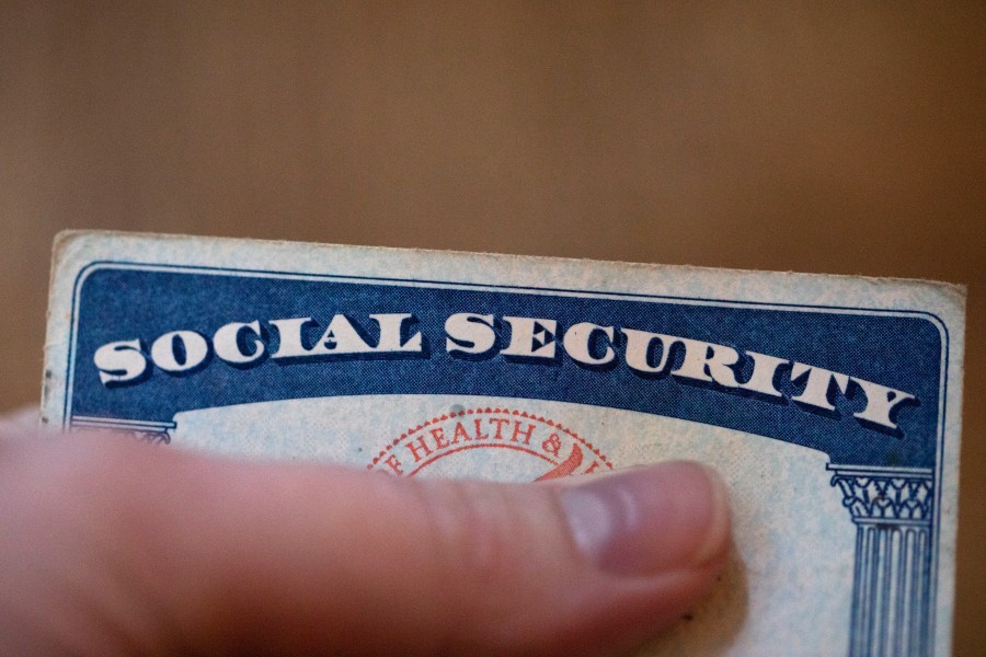 FILE - A Social Security card is displayed on Oct. 12, 2021, in Tigard, Ore. Most U.S. adults are opposed to proposals that would cut into Medicare or Social Security benefits, and a majority support raising taxes on the nation's highest earners to keep Medicare running as is. The new findings, revealed in a March poll by The Associated Press-NORC Center for Public Affairs Research, come as both safety net programs are poised to run out of enough cash to pay out full benefits within the next decade. (AP Photo/Jenny Kane, File)