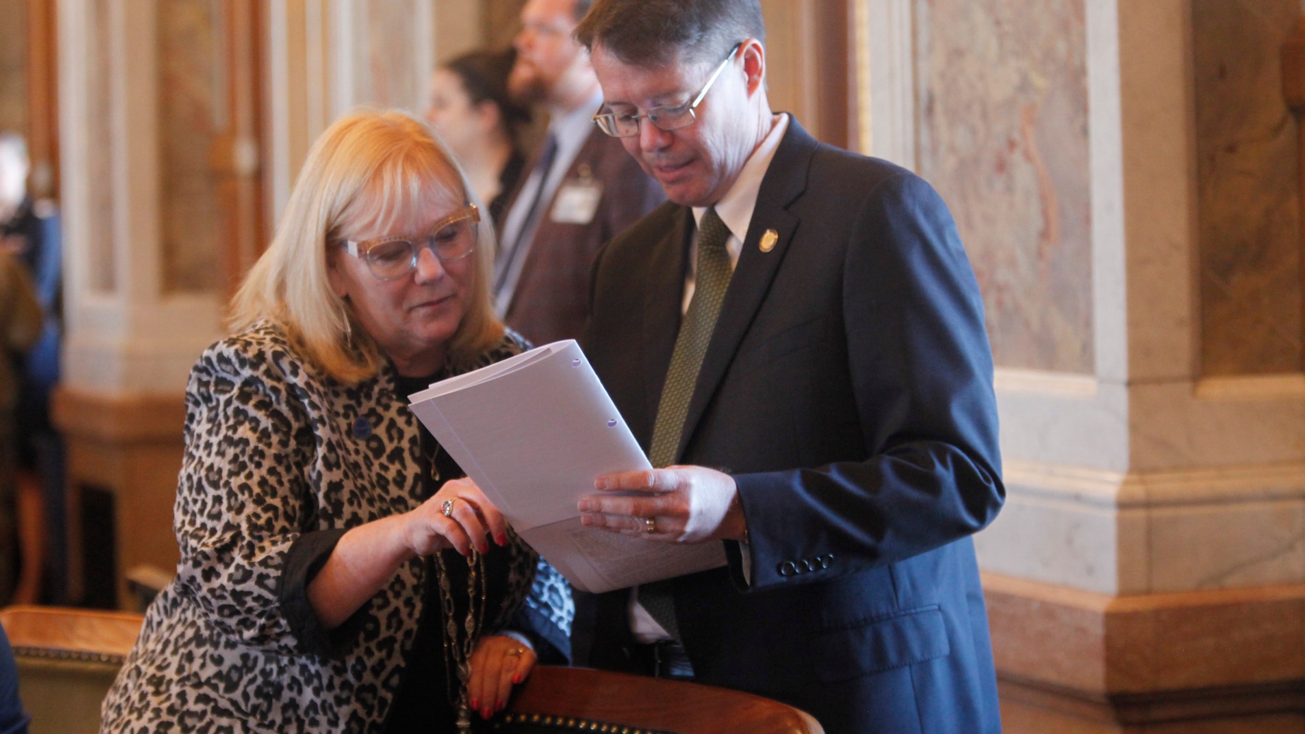 Kansas state Reps. Susan Concannon, left, R-Beloit, and Fred Patton, right, R-Topeka, confer during a session of the House, Thursday, April 6, 2023, at the Statehouse in Topeka, Kan. Both Concannon and Patton supported a bill approved by lawmakers that would require abortion providers to tell patients that medication abortions can be "reversed" once they are started, something experts dispute. (AP Photo/John Hanna)