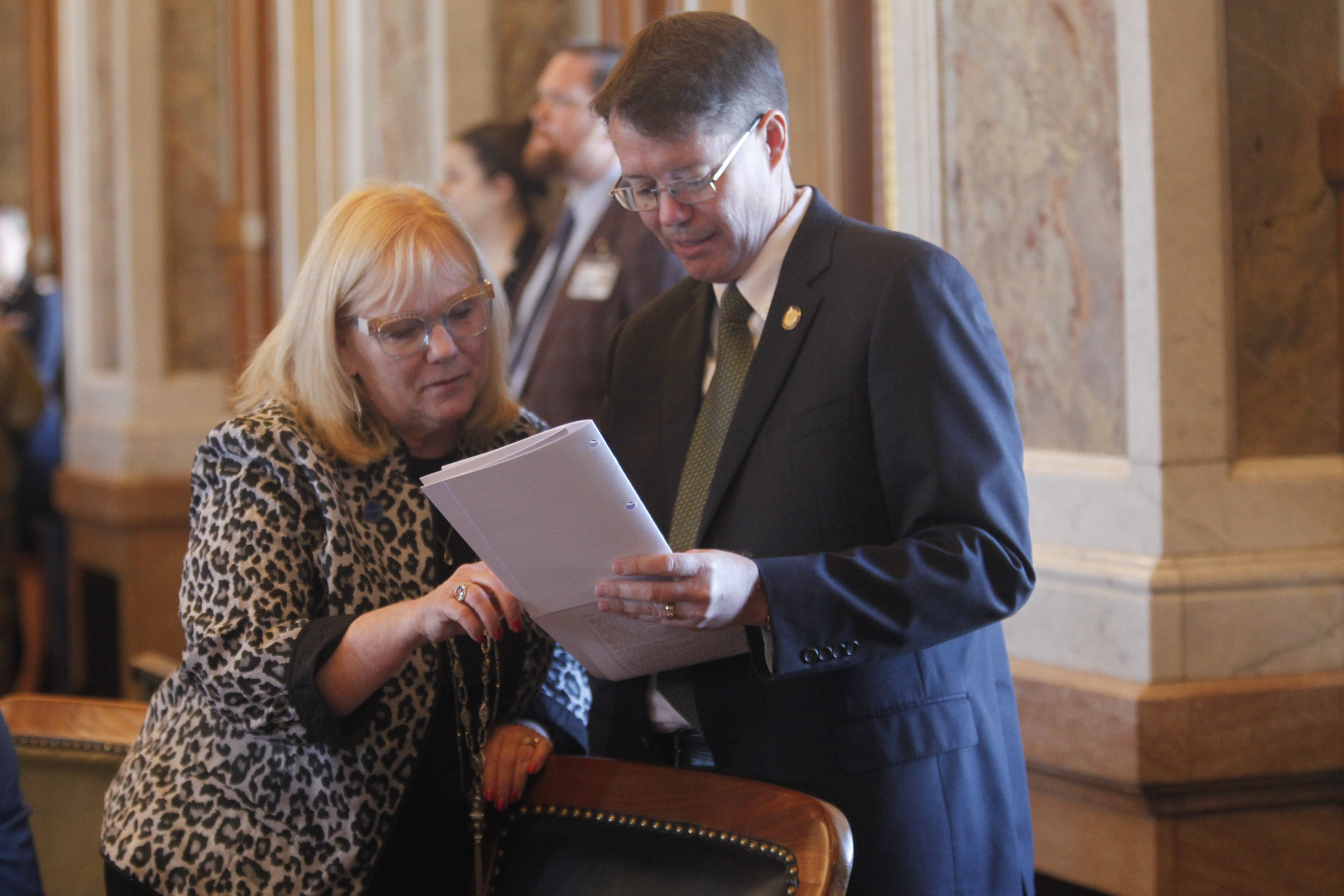 Kansas state Reps. Susan Concannon, left, R-Beloit, and Fred Patton, right, R-Topeka, confer during a session of the House, Thursday, April 6, 2023, at the Statehouse in Topeka, Kan. Both Concannon and Patton supported a bill approved by lawmakers that would require abortion providers to tell patients that medication abortions can be "reversed" once they are started, something experts dispute. (AP Photo/John Hanna)