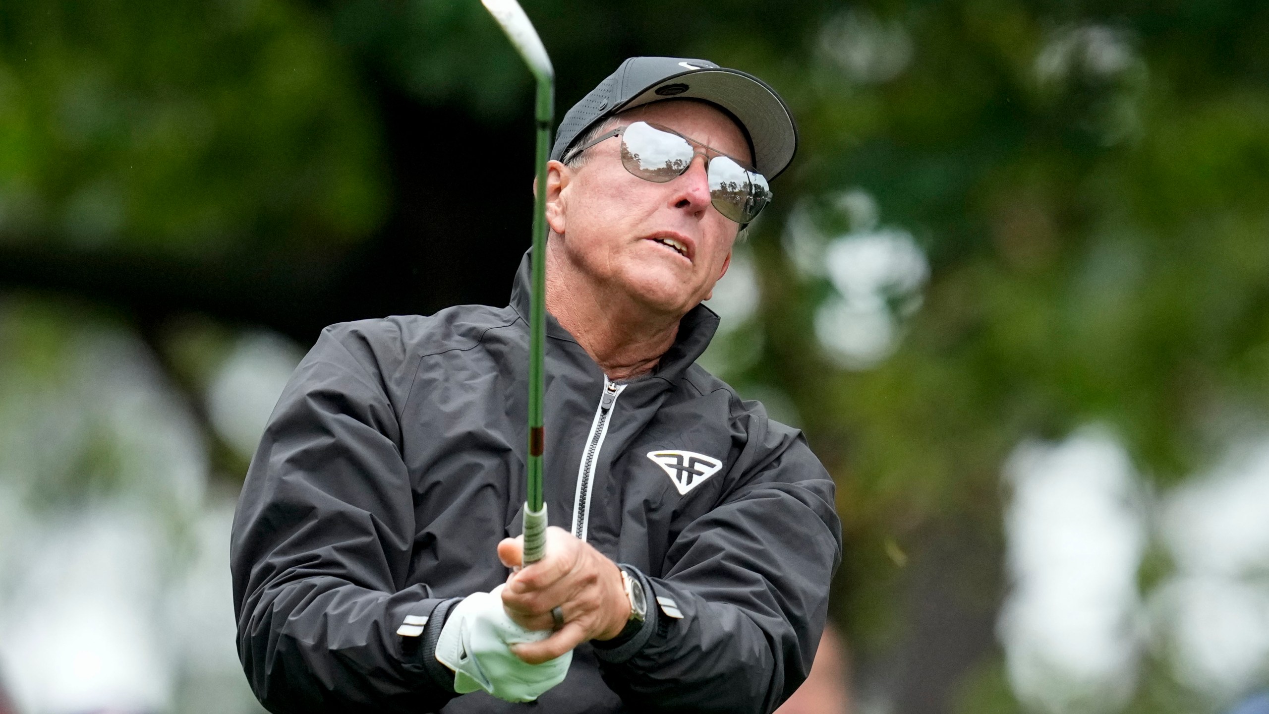 Phil Mickelson watches his tee shot on the fourth hole during the weather delayed third round of the Masters golf tournament at Augusta National Golf Club on Saturday, April 8, 2023, in Augusta, Ga. (AP Photo/Mark Baker)