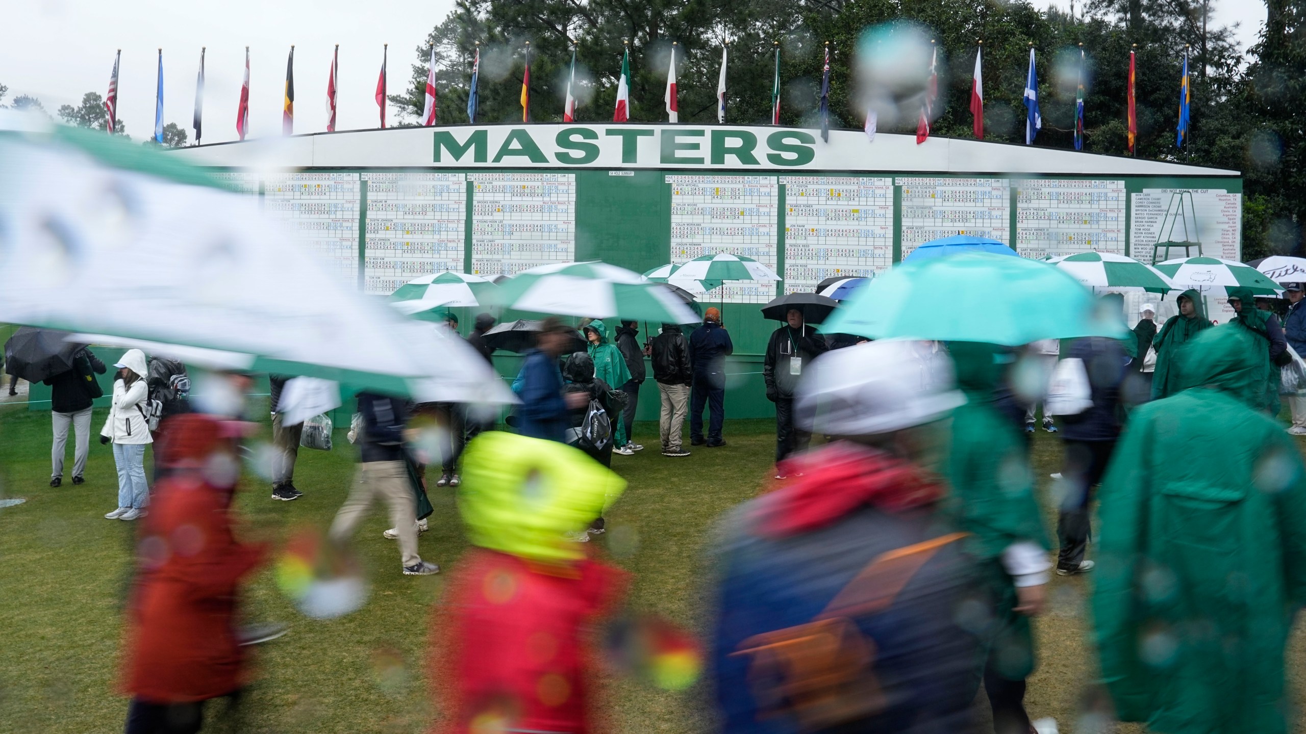 Patrons leave the course after play was suspended for the day in the weather delayed third round of the Masters golf tournament at Augusta National Golf Club on Saturday, April 8, 2023, in Augusta, Ga.(AP Photo/David J. Phillip)