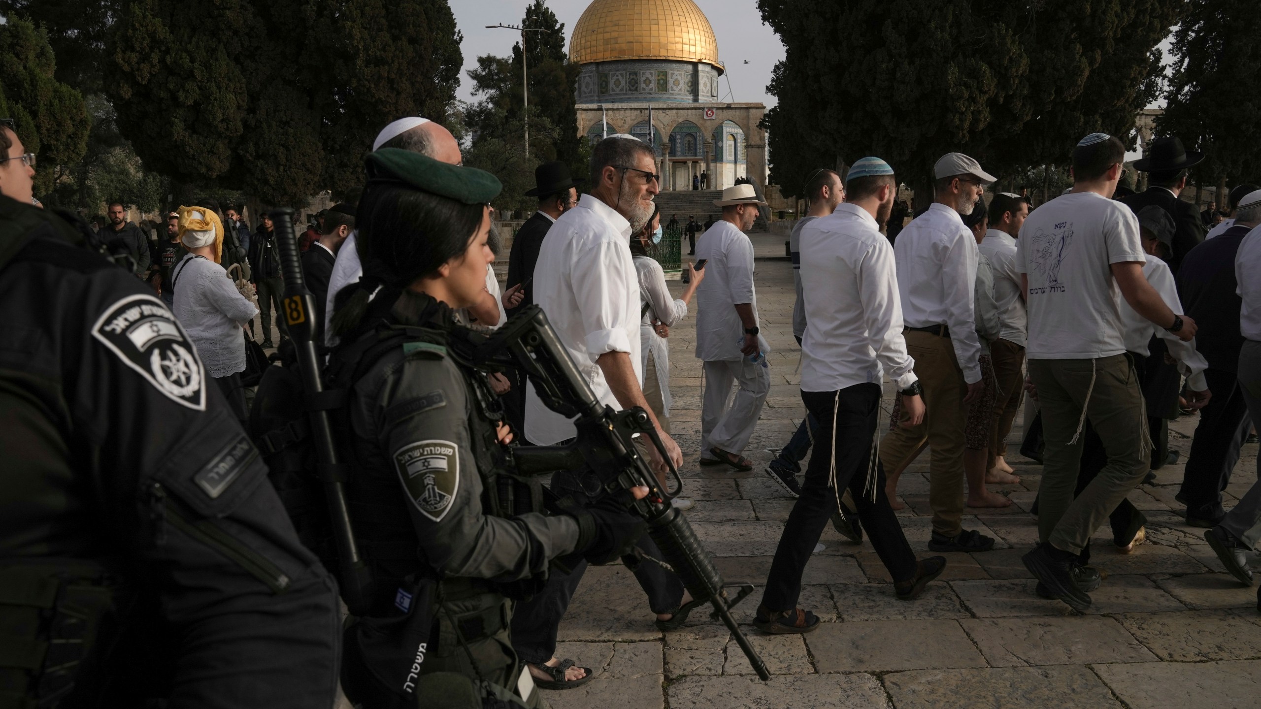 Israeli police escort Jewish visitors marking the holiday pf Passover to the Al-Aqsa Mosque compound, known to Muslims as the Noble Sanctuary and to Jews as the Temple Mount, in the Old City of Jerusalem during the Muslim holy month of Ramadan, Sunday, April 9, 2023. (AP Photo/Mahmoud Illean)