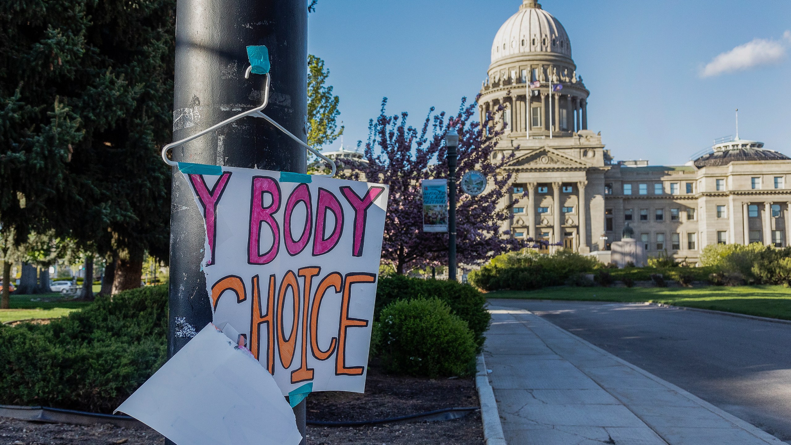 FILE - A sign reading "My body, my choice," is taped to a hanger taped to a streetlight in front of the Idaho state Capitol Building in Boise, Idaho, May 3, 2022. Abortion is banned in Idaho at all stages of pregnancy, but the governor on Wednesday, April 5, 2023 signed another law making it illegal to provide help within the state’s boundaries to minors seeking abortion without parental consent. (Sarah A. Miller/Idaho Statesman via AP, File)