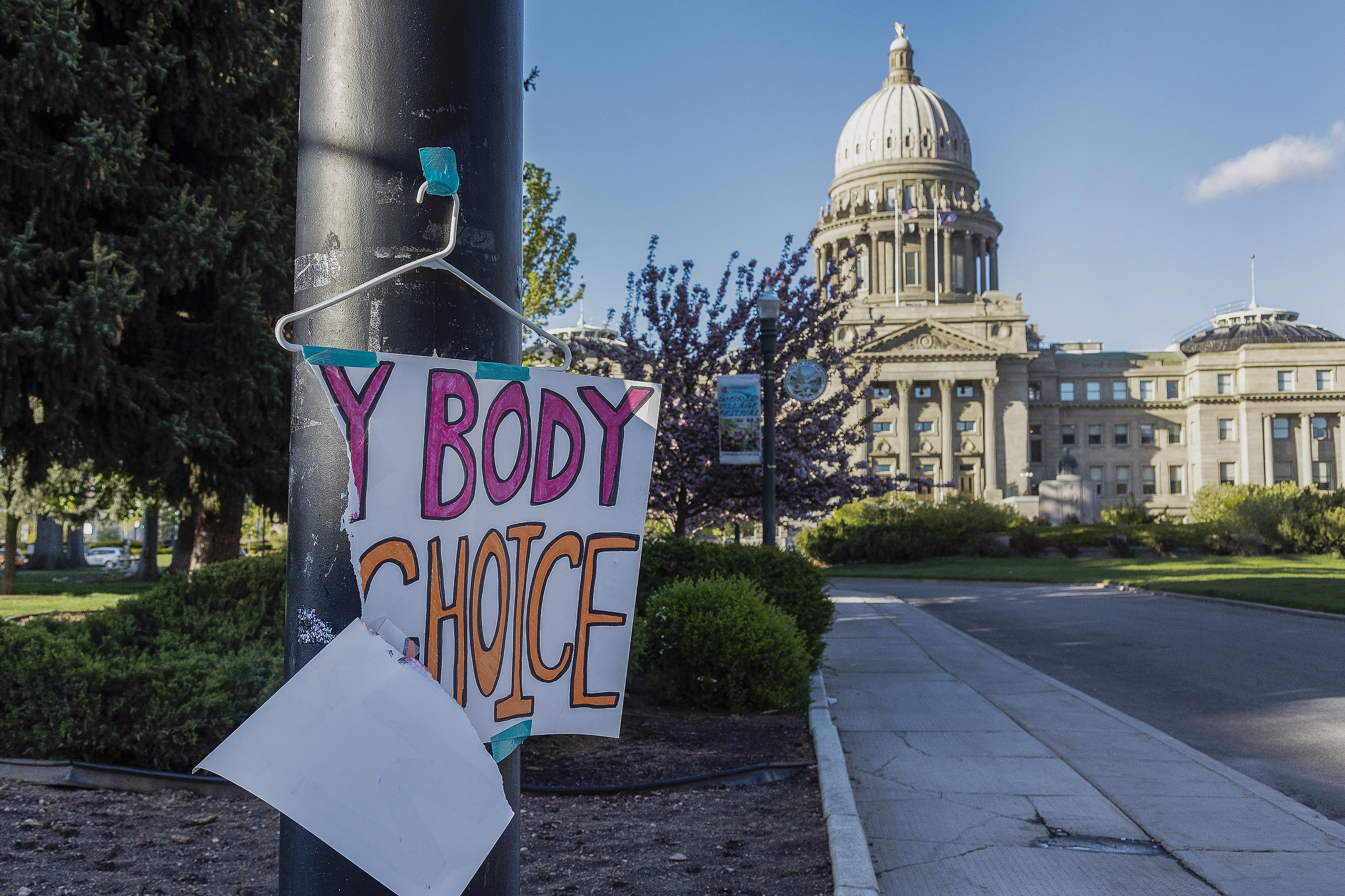 FILE - A sign reading "My body, my choice," is taped to a hanger taped to a streetlight in front of the Idaho state Capitol Building in Boise, Idaho, May 3, 2022. Abortion is banned in Idaho at all stages of pregnancy, but the governor on Wednesday, April 5, 2023 signed another law making it illegal to provide help within the state’s boundaries to minors seeking abortion without parental consent. (Sarah A. Miller/Idaho Statesman via AP, File)