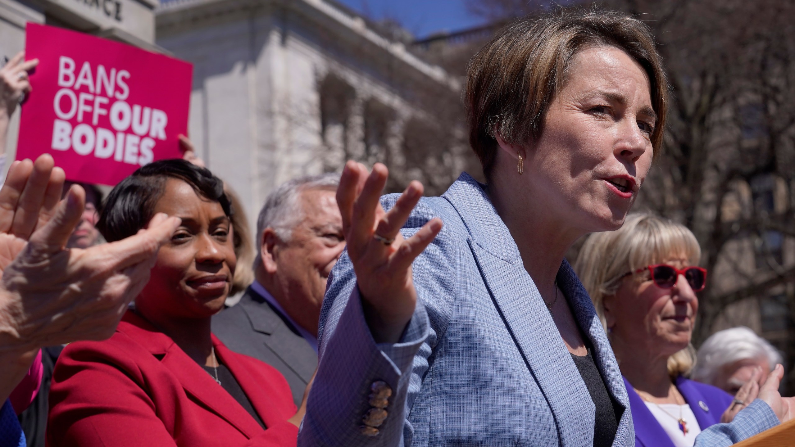 Gov. Maura Healey, front right, faces reporters as Massachusetts Attorney General Andrea Campbell, left, looks on, Monday, April 10, 2023, during a news conference in front of the Statehouse, in Boston. Massachusetts is stockpiling enough doses of mifepristone to last for more than a year Healey, a Democrat, said Monday. (AP Photo/Steven Senne)