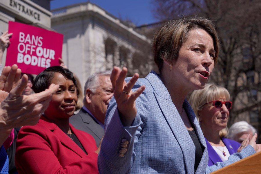 Gov. Maura Healey, front right, faces reporters as Massachusetts Attorney General Andrea Campbell, left, looks on, Monday, April 10, 2023, during a news conference in front of the Statehouse, in Boston. Massachusetts is stockpiling enough doses of mifepristone to last for more than a year Healey, a Democrat, said Monday. (AP Photo/Steven Senne)