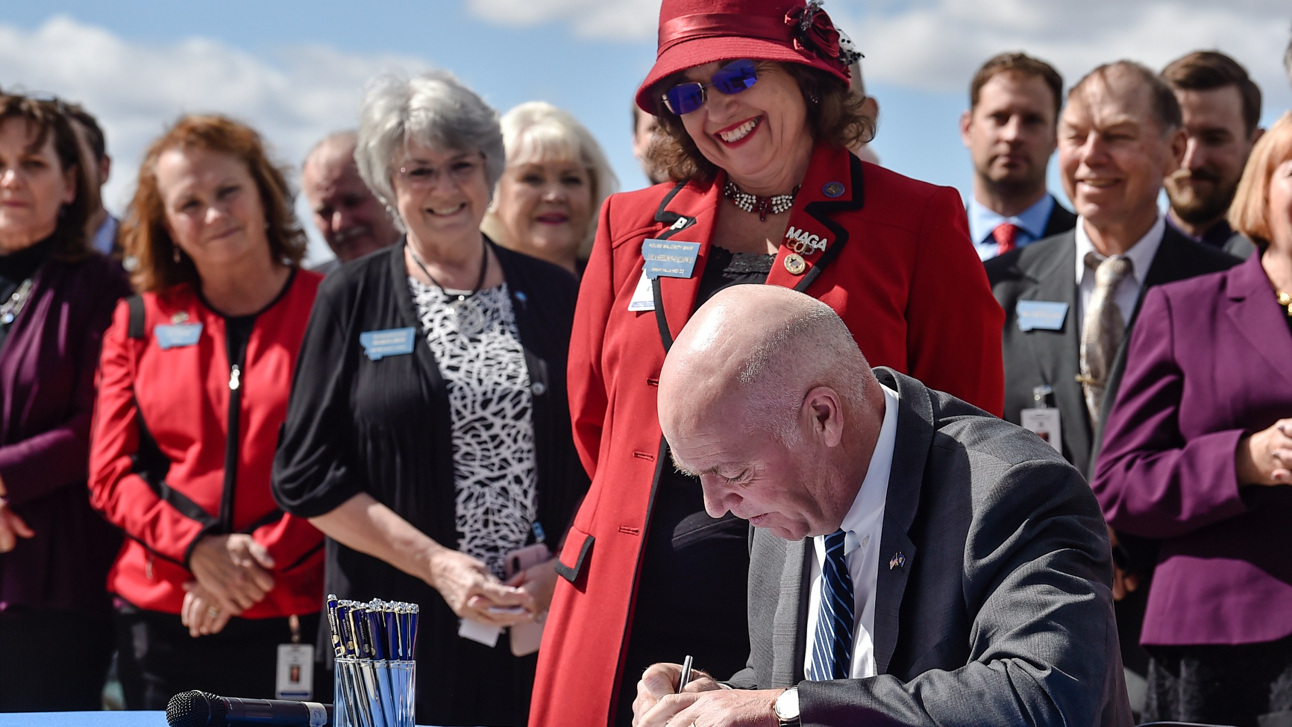 FILE - Republican Gov. Greg Gianforte signs one of three bills restricting access to abortion in Montana as sponsor of one of the bills, state Rep. Lola Sheldon-Galloway, R-Great Falls, watches in Helena, Mont., on April 26, 2021. Planned Parenthood of Montana filed a preemptive lawsuit Monday, April 10, 2023, seeking to stop legislation that would ban the abortion method most commonly used in the second trimester, arguing it's unconstitutional. (Thom Bridge/Independent Record via AP, File)