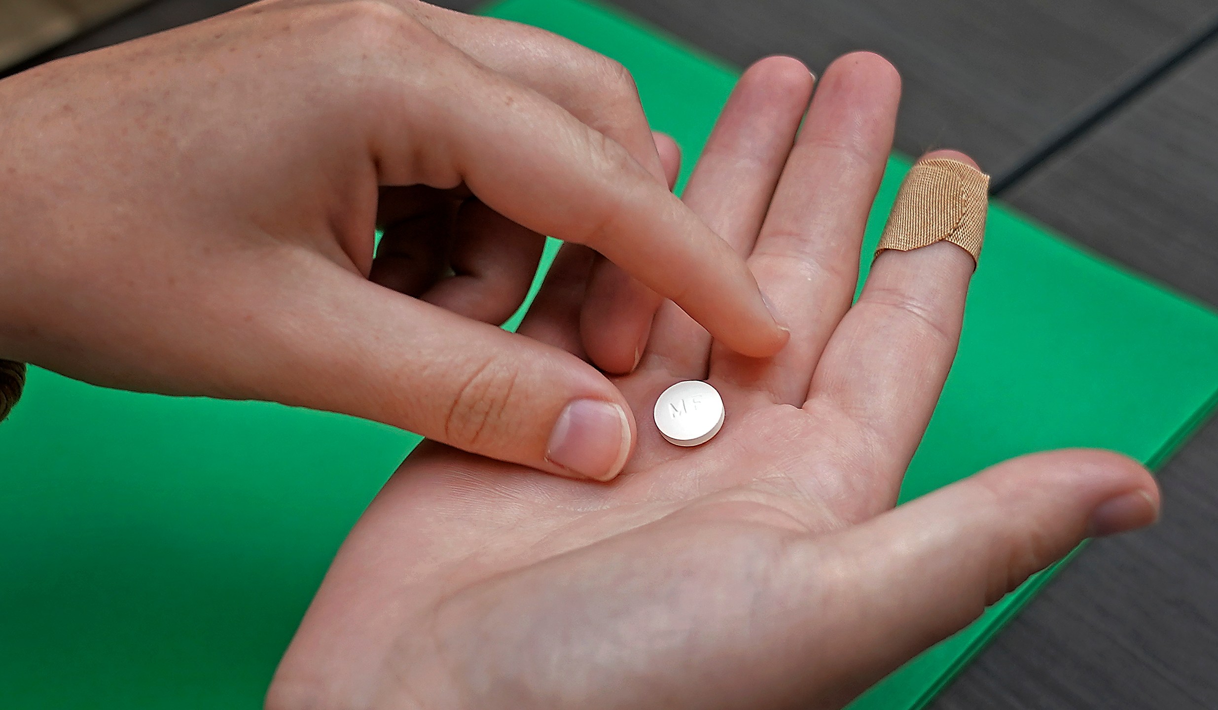 FILE - A patient prepares to take the first of two pills for a medication abortion during a visit to a clinic in Kansas City, Kan., on Wednesday, Oct. 12, 2022. Some abortion clinics are fielding lots of calls from patients since a Friday, April 7, 2023 court ruling threatened the availability of a main drug used in medication abortion, mifepristone. Patients are concerned about whether they can still get the care they need. (AP Photo/Charlie Riedel, File)