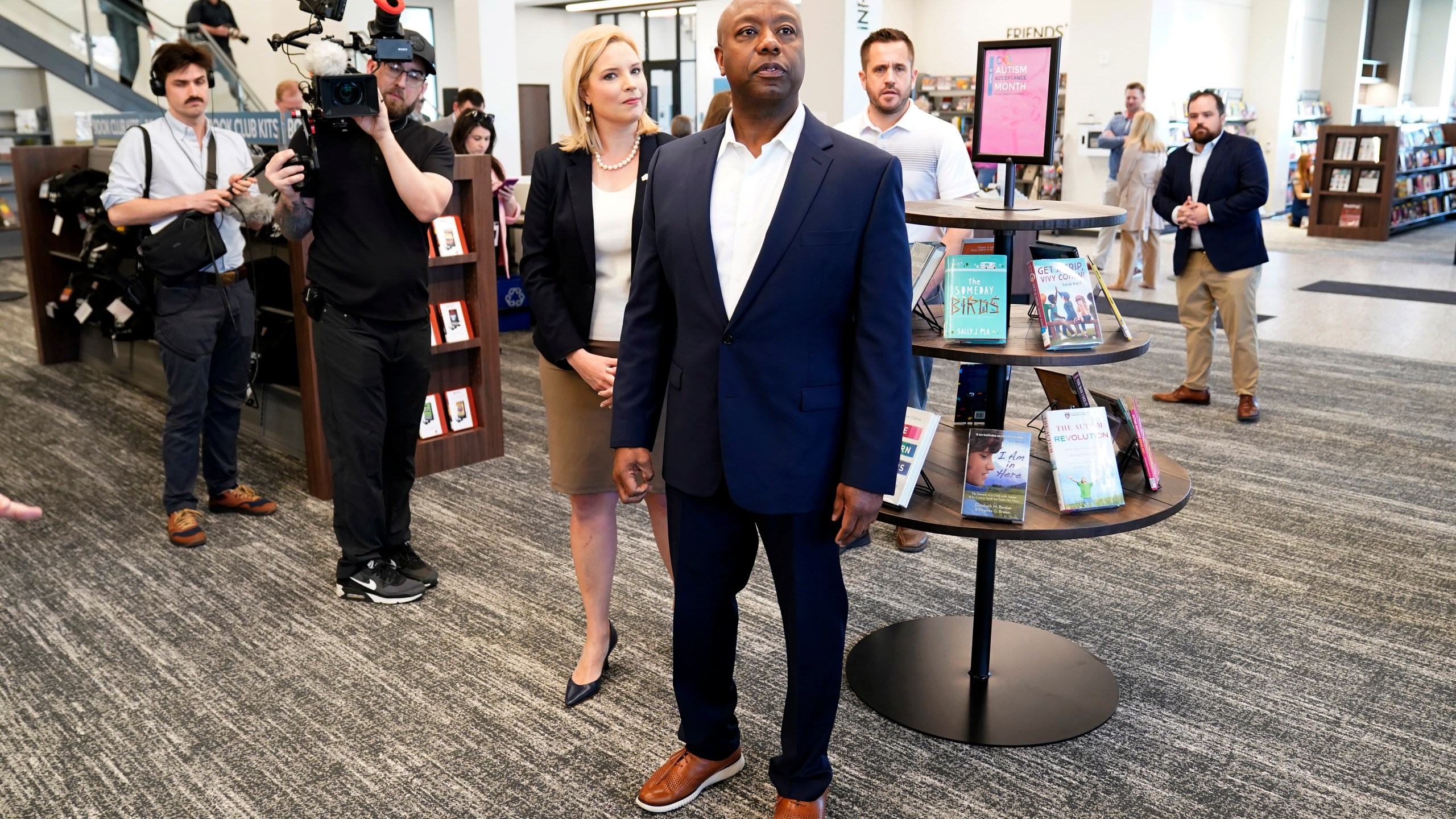 Sen. Tim Scott, R-S.C., tours the Marion Public Library, Wednesday, April 12, 2023, in Marion, Iowa. Scott on Wednesday launched an exploratory committee for a 2024 GOP presidential bid, a step that comes just shy of making his campaign official. (AP Photo/Charlie Neibergall)