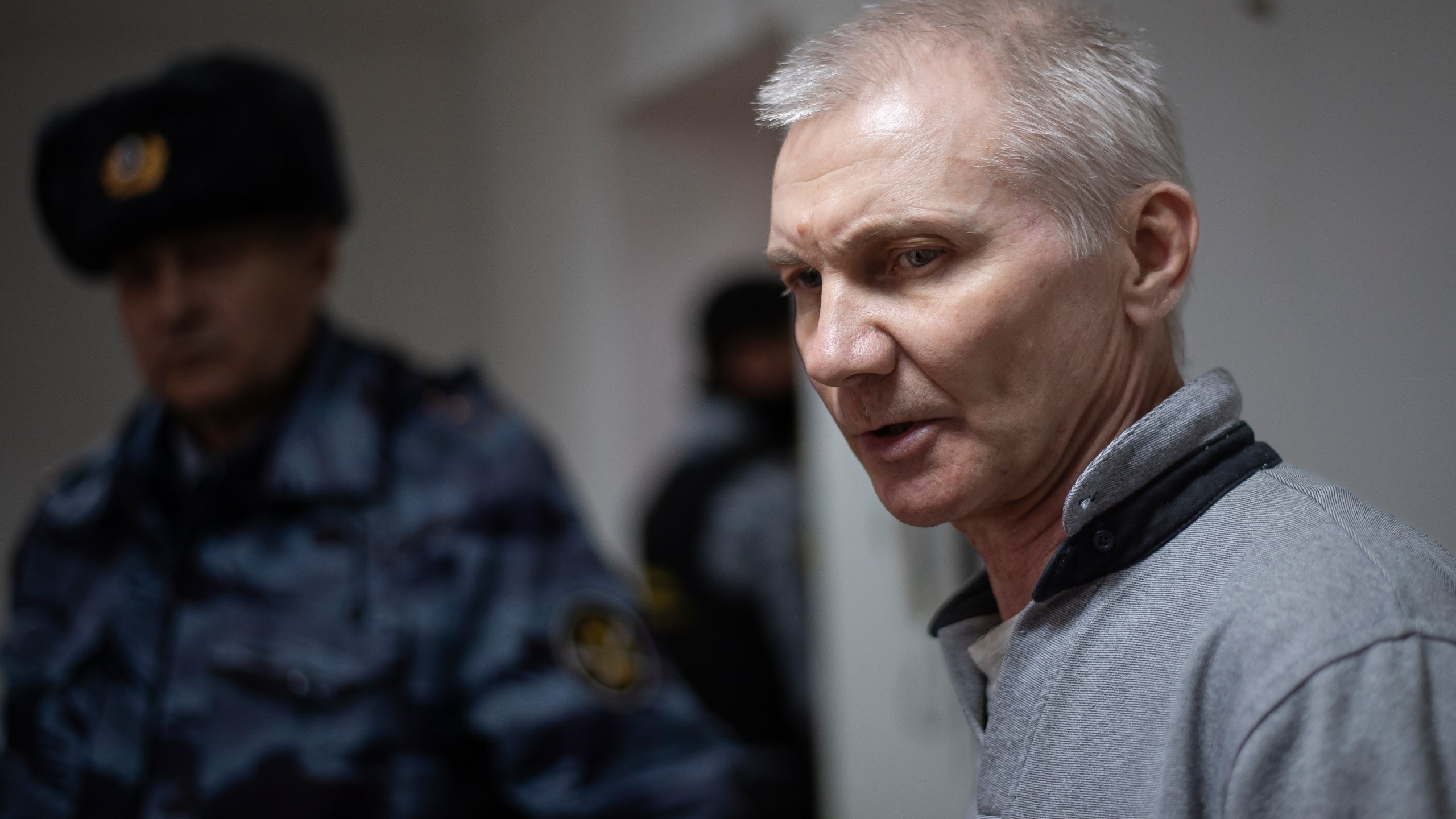 Alexei Moskalyov, right, is escorted from a courtroom in Yefremov, Tula region, some 300 kilometers (186 miles) south of Moscow, Russia, Monday, March 27, 2023. A court in Russia on Tuesday convicted a single father over social media posts criticizing the war in Ukraine and sentenced him to two years in prison — a case brought to the attention of authorities by his daughter's drawings against the invasion at school, according to the man's lawyer and local activists. The 54-year-old Moskalyov, a single father of a 13-year-old daughter, was accused of repeatedly discrediting the Russian army, a criminal offense in accordance to a law Russian authorities adopted shortly after sending troops into Ukraine. (AP Photo)