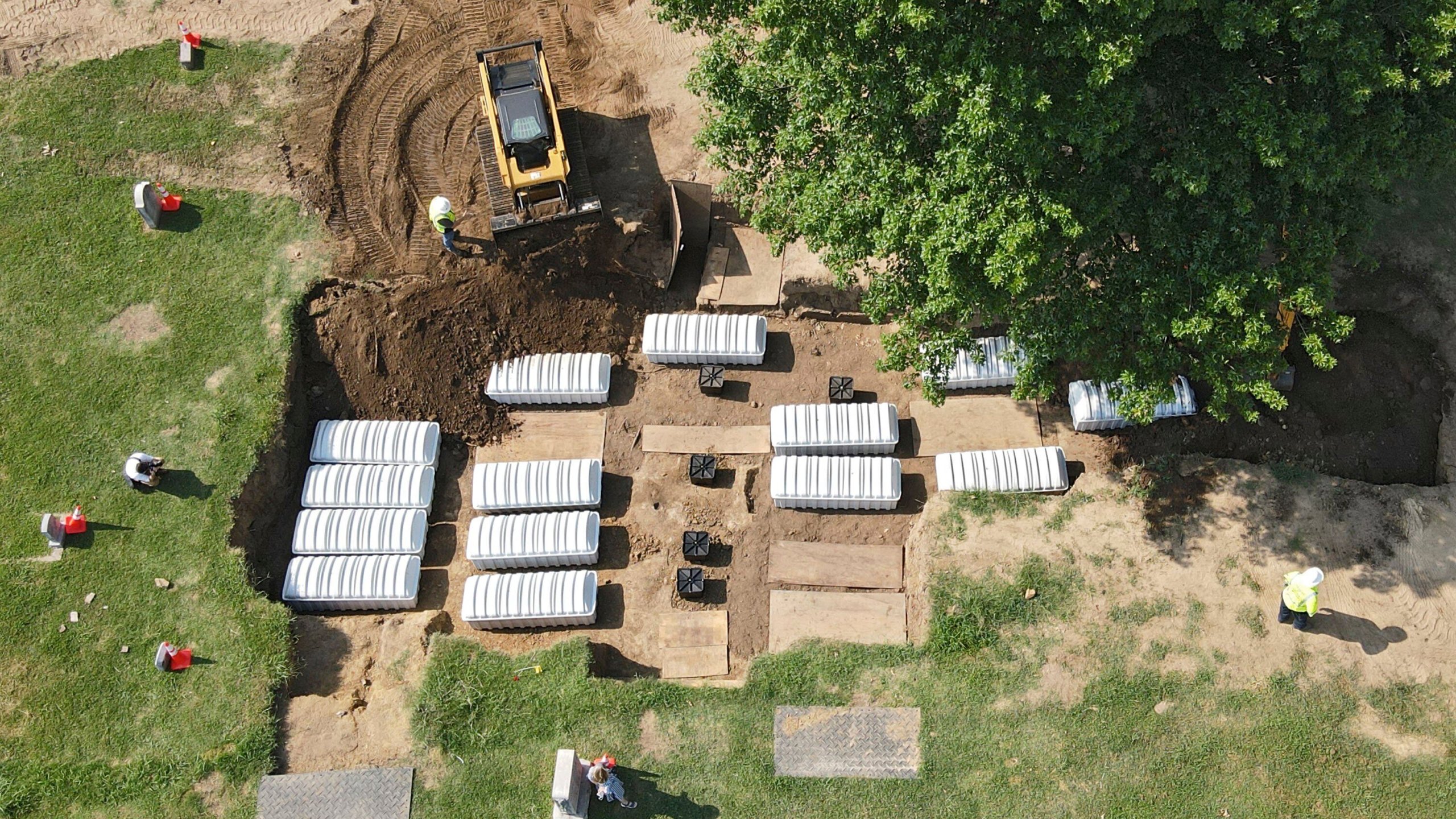 FILE - In this aerial photo, a mass grave is re-filled with dirt after a small ceremony at Oaklawn Cemetery, July 30, 2021, in Tulsa, Okla. The mass grave was discovered while searching for victims of the Tulsa Race Massacre. A forensic anthropologist believes investigators are a step closer to identifying victims of the 1921 Tulsa Race Massacre with the discovery of 19 surnames possibly connected to remains excavated from the Tulsa cemetery. (Mike Simons/Tulsa World via AP, File)/Tulsa World via AP)