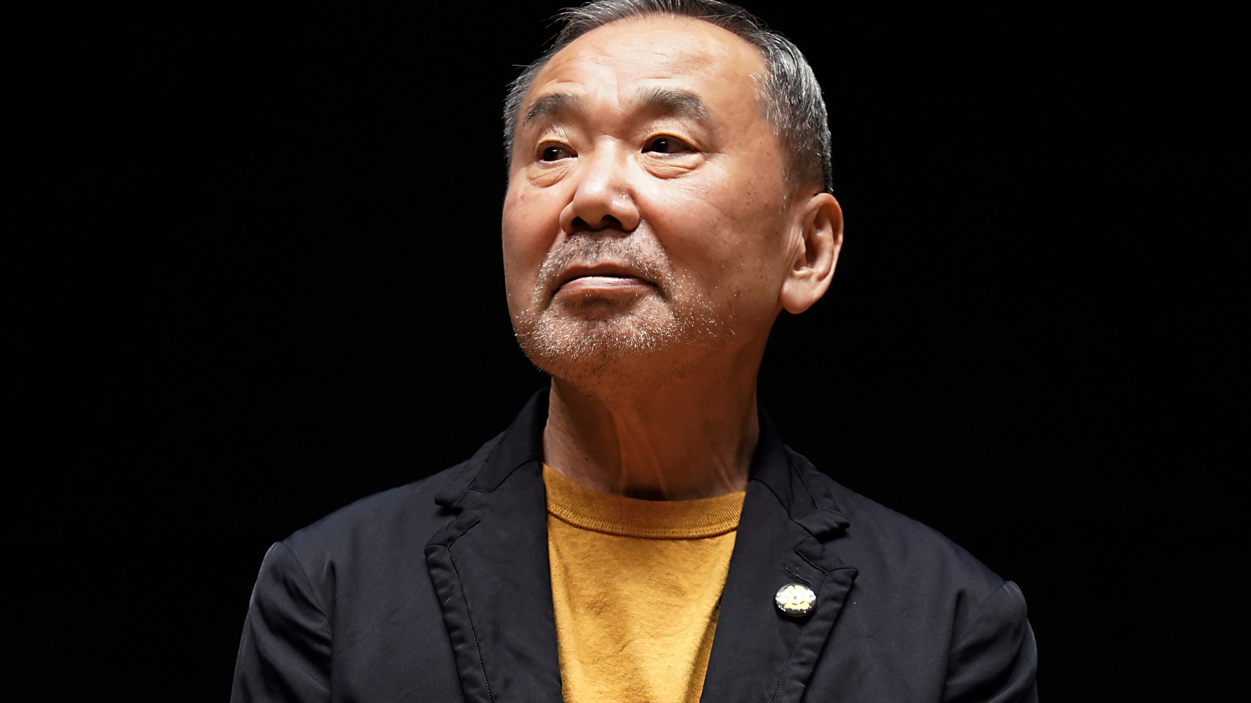 FILE - Japanese novelist Haruki Murakami poses for media members during a news conference on the university's new international house of literature as known as The Haruki Murakami Library at the Waseda University in Tokyo on Sept. 22, 2021. Murakami wrote a story of a walled city when he was fresh off his debut. More than four decades later, as a seasoned and acclaimed novelist, he gave it a new life as “The City and Its Uncertain Walls.” (AP Photo/Eugene Hoshiko, File)