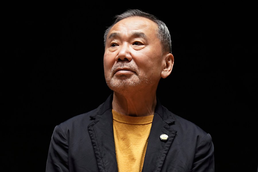 FILE - Japanese novelist Haruki Murakami poses for media members during a news conference on the university's new international house of literature as known as The Haruki Murakami Library at the Waseda University in Tokyo on Sept. 22, 2021. Murakami wrote a story of a walled city when he was fresh off his debut. More than four decades later, as a seasoned and acclaimed novelist, he gave it a new life as “The City and Its Uncertain Walls.” (AP Photo/Eugene Hoshiko, File)