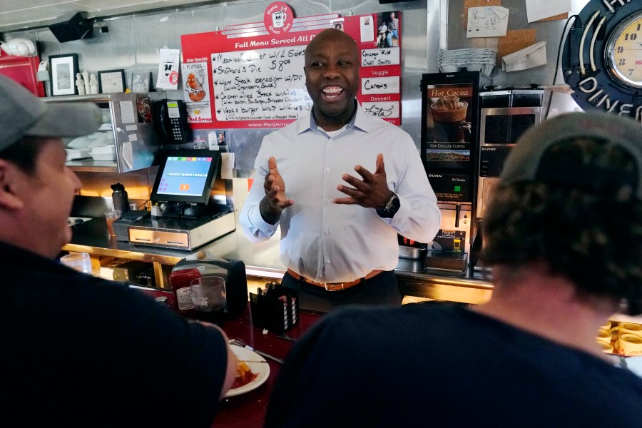 Sen. Tim Scott, R-S.C., talks with diners at the breakfast counter during a visit to the Red Arrow Diner, Thursday, April 13, 2023, in Manchester, N.H. Scott on Wednesday launched an exploratory committee for a 2024 GOP presidential bid, a step that comes just shy of making his campaign official. (AP Photo/Charles Krupa)