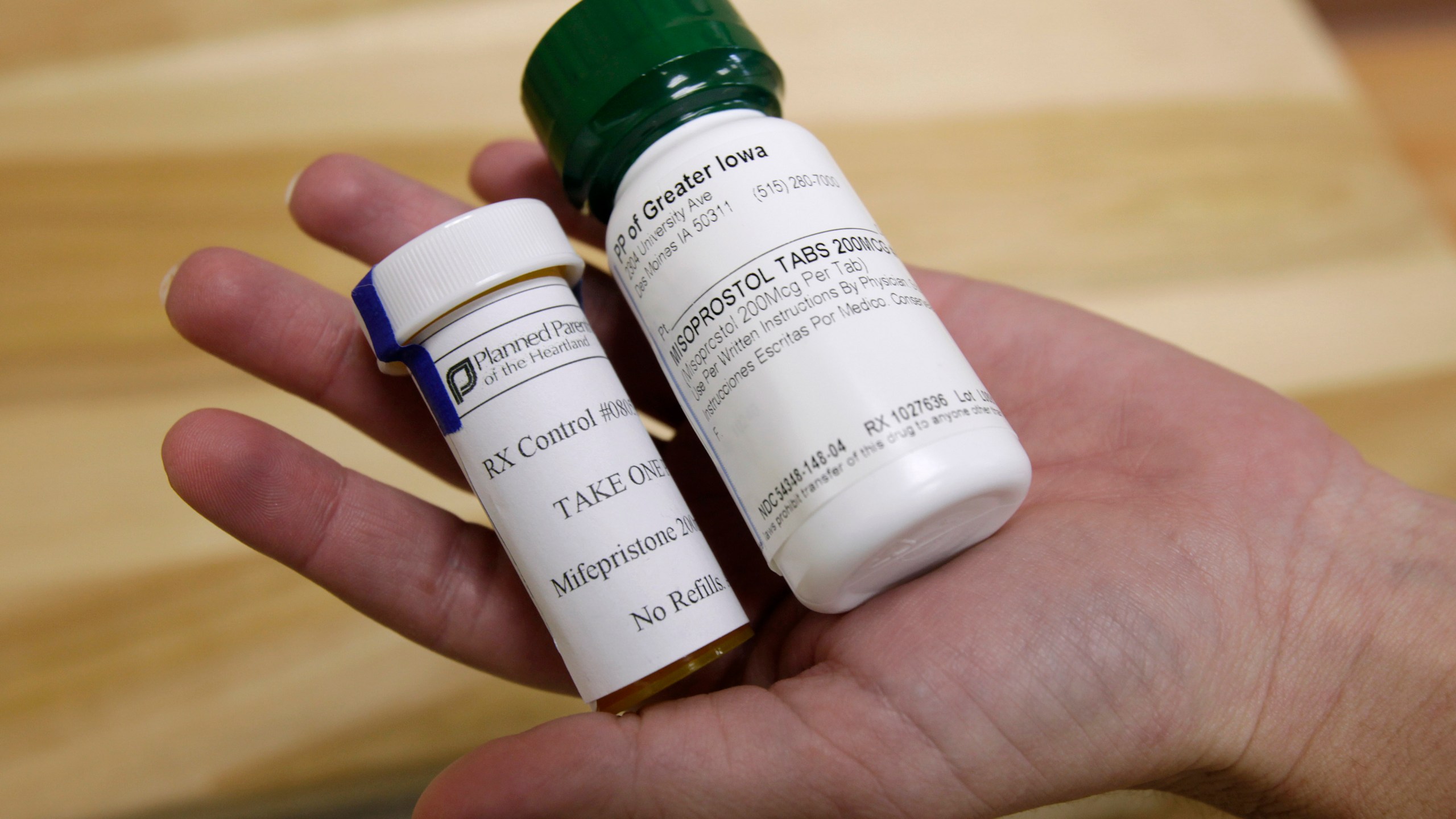 FILE - Bottles of abortion pills mifepristone, left, and misoprostol, right, at a clinic in Des Moines, Iowa, Sept. 22, 2010. A federal appeals court has preserved access to an abortion drug for now but under tighter rules that would allow the drug only to be dispensed up to seven weeks, not 10, and not by mail. (AP Photo/Charlie Neibergall, File)