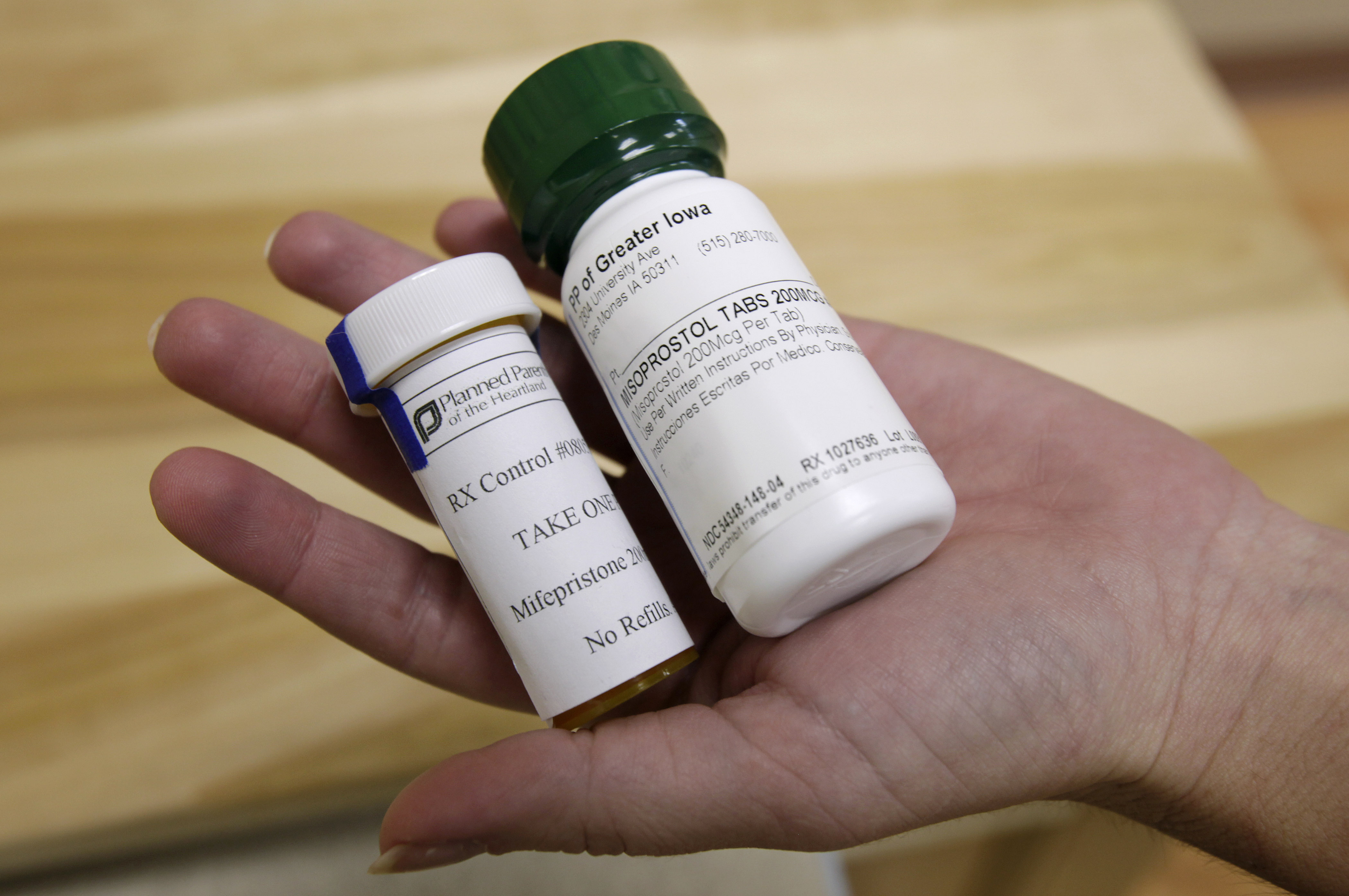 FILE - Bottles of abortion pills mifepristone, left, and misoprostol, right, at a clinic in Des Moines, Iowa, Sept. 22, 2010. A federal appeals court has preserved access to an abortion drug for now but under tighter rules that would allow the drug only to be dispensed up to seven weeks, not 10, and not by mail. (AP Photo/Charlie Neibergall, File)