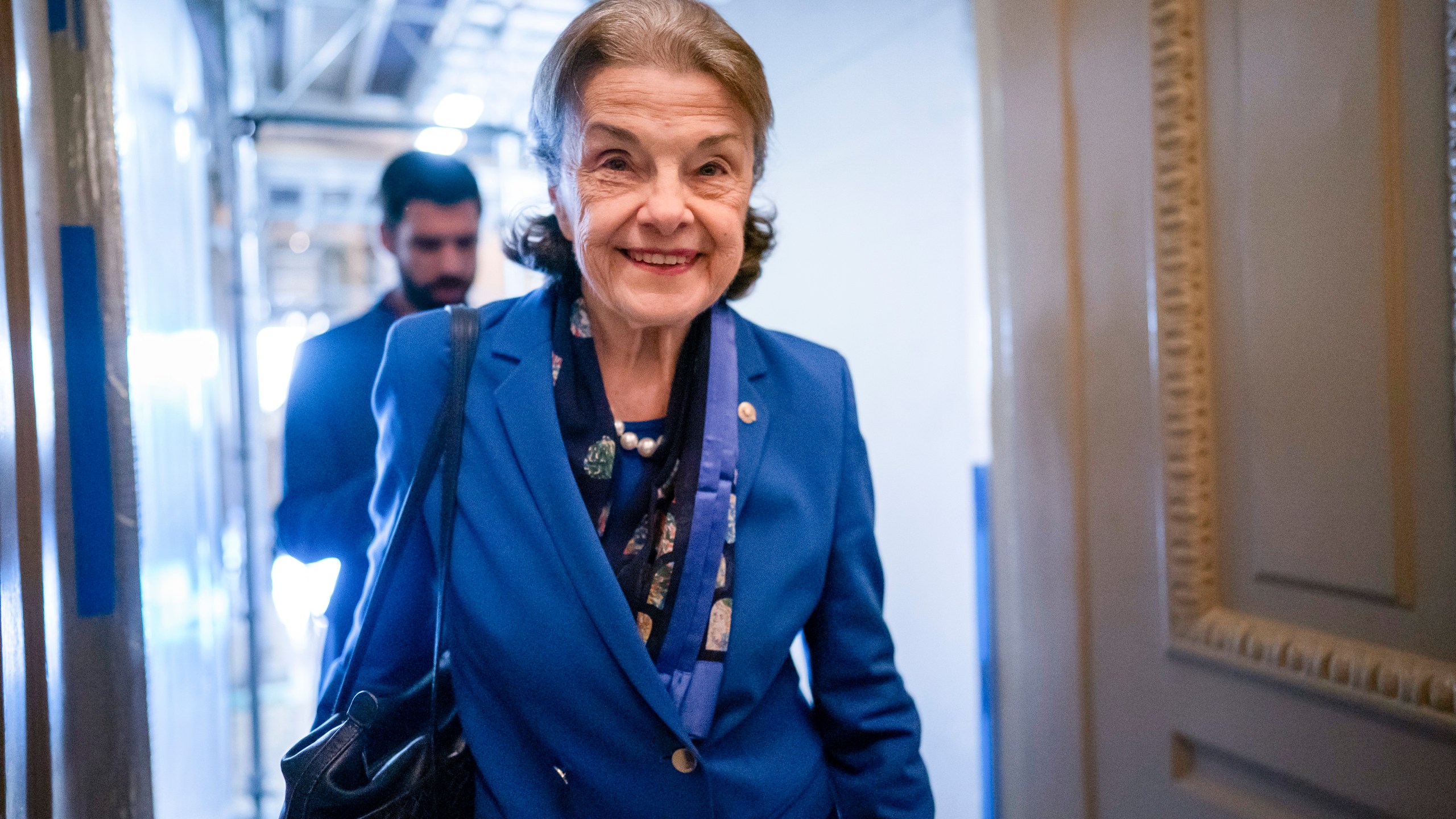 FILE - Sen. Dianne Feinstein, D-Calif., walks through a Senate corridor after telling her Democratic colleagues that she will not seek reelection in 2024, at the Capitol in Washington, Feb. 14, 2023. Feinstein's months-long absence from the Senate has become a growing problem for Democrats. Feinstein's vote is critical to confirm President Joe Biden's nominees to the federal courts, but Feinstein is away from the Senate indefinitely as she recovers from the shingles.(AP Photo/J. Scott Applewhite, File)