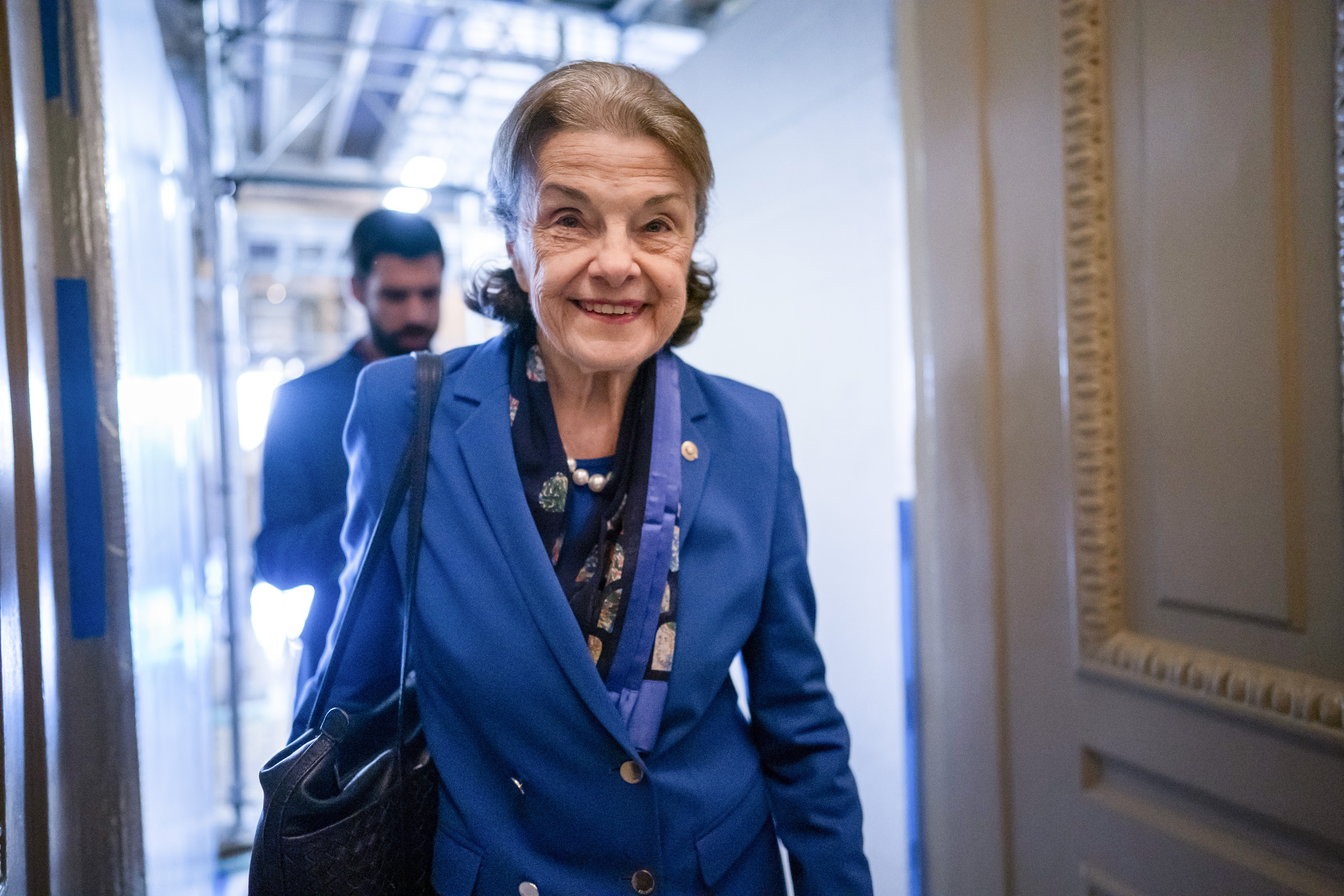 FILE - Sen. Dianne Feinstein, D-Calif., walks through a Senate corridor after telling her Democratic colleagues that she will not seek reelection in 2024, at the Capitol in Washington, Feb. 14, 2023. Feinstein's months-long absence from the Senate has become a growing problem for Democrats. Feinstein's vote is critical to confirm President Joe Biden's nominees to the federal courts, but Feinstein is away from the Senate indefinitely as she recovers from the shingles.(AP Photo/J. Scott Applewhite, File)