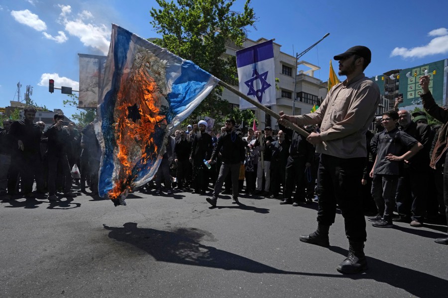 Iranian demonstrators burn a representation of the Israeli flag in their rally to mark Jerusalem Day, an annual show of support for the Palestinians, in Tehran, Iran, Friday, April 14, 2023. (AP Photo/Vahid Salemi)