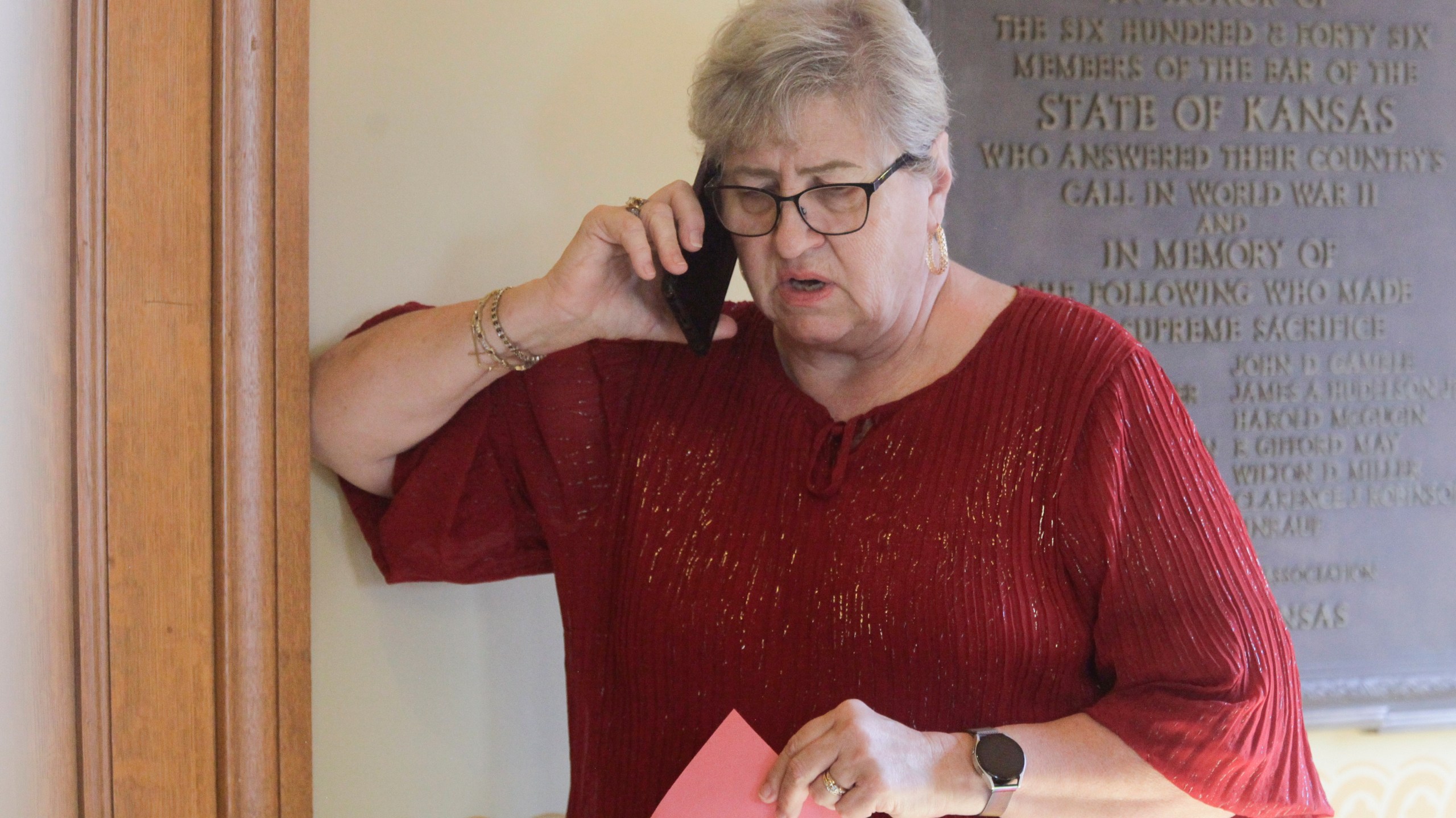 FILE - Kansas House Health Committee Chair Brenda Landwehr, R-Wichita, talks on the phone with GOP colleagues outside a caucus meeting and ahead of a vote on a proposed "born alive infants protection" law, Tuesday, April 4, 2023, at the Statehouse in Topeka, Kan. Under the measure, doctors could face lawsuits and criminal charges over allegations of not providing reasonable medical care for infants born during abortion procedures. But on Friday, April 14, Kansas Gov. Laura Kelly vetoed the bill. (AP Photo/John Hanna)