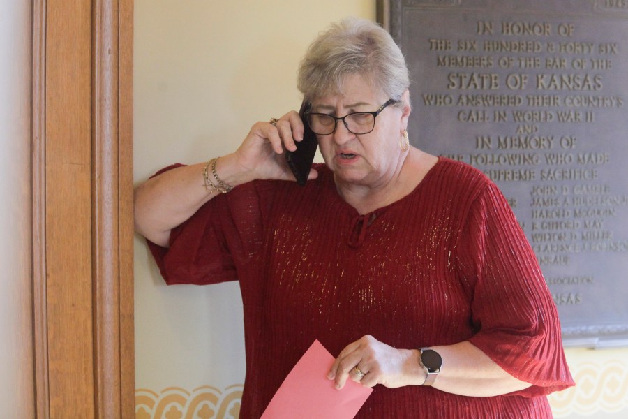 FILE - Kansas House Health Committee Chair Brenda Landwehr, R-Wichita, talks on the phone with GOP colleagues outside a caucus meeting and ahead of a vote on a proposed "born alive infants protection" law, Tuesday, April 4, 2023, at the Statehouse in Topeka, Kan. Under the measure, doctors could face lawsuits and criminal charges over allegations of not providing reasonable medical care for infants born during abortion procedures. But on Friday, April 14, Kansas Gov. Laura Kelly vetoed the bill. (AP Photo/John Hanna)