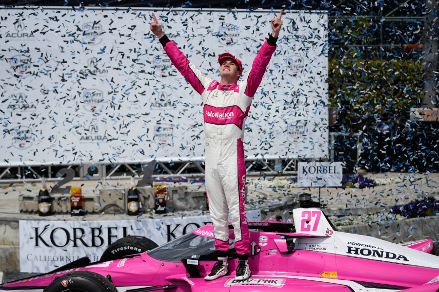 Kyle Kirkwood celebrates during the victory ceremony after winning the IndyCar Grand Prix of Long Beach auto race, Sunday, April 16, 2023, in Long Beach, Calif. (AP Photo/Jae C. Hong)