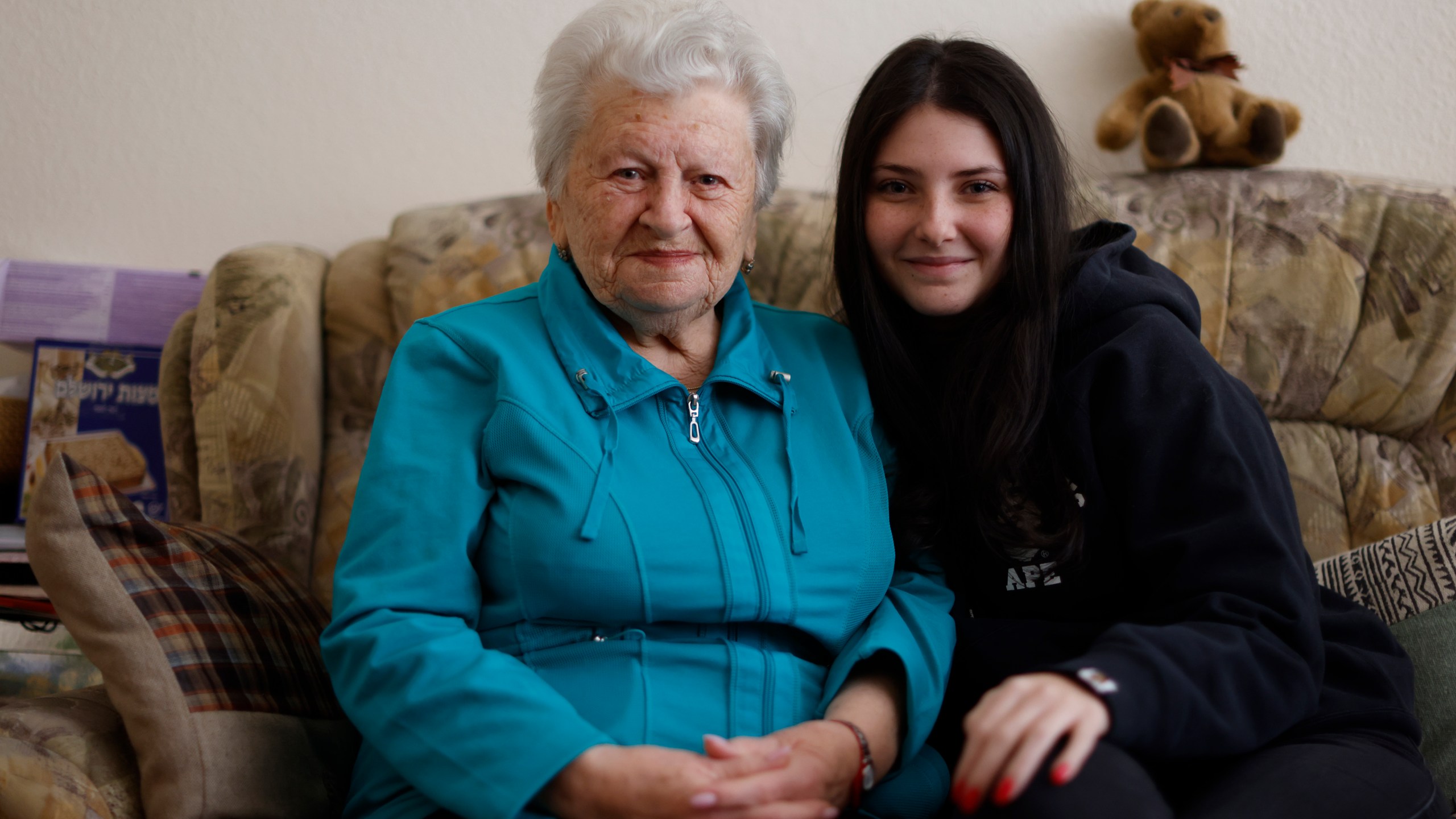 Holocaust survivor Assia Gorban, left, and her granddaughter Ruth Gorban pose during an interview with The Associated Press in Berlin, Germany, Monday, April 3, 2023. Assia Gorman and her granddaughter, 19-year-old Ruth Gorban, are taking part in the new digital campaign Our Holocaust Story: A Pledge to Remember. The campaign launched by the New York-based Conference on Jewish Material Claims Against Germany, also referred to as the Claims Conference, features survivors and their descendants from around the world and illustrates the importance of passing on the testimonies of Holocaust survivors to younger family members as the number of survivors dwindles. (AP Photo/Michele Tantussi)