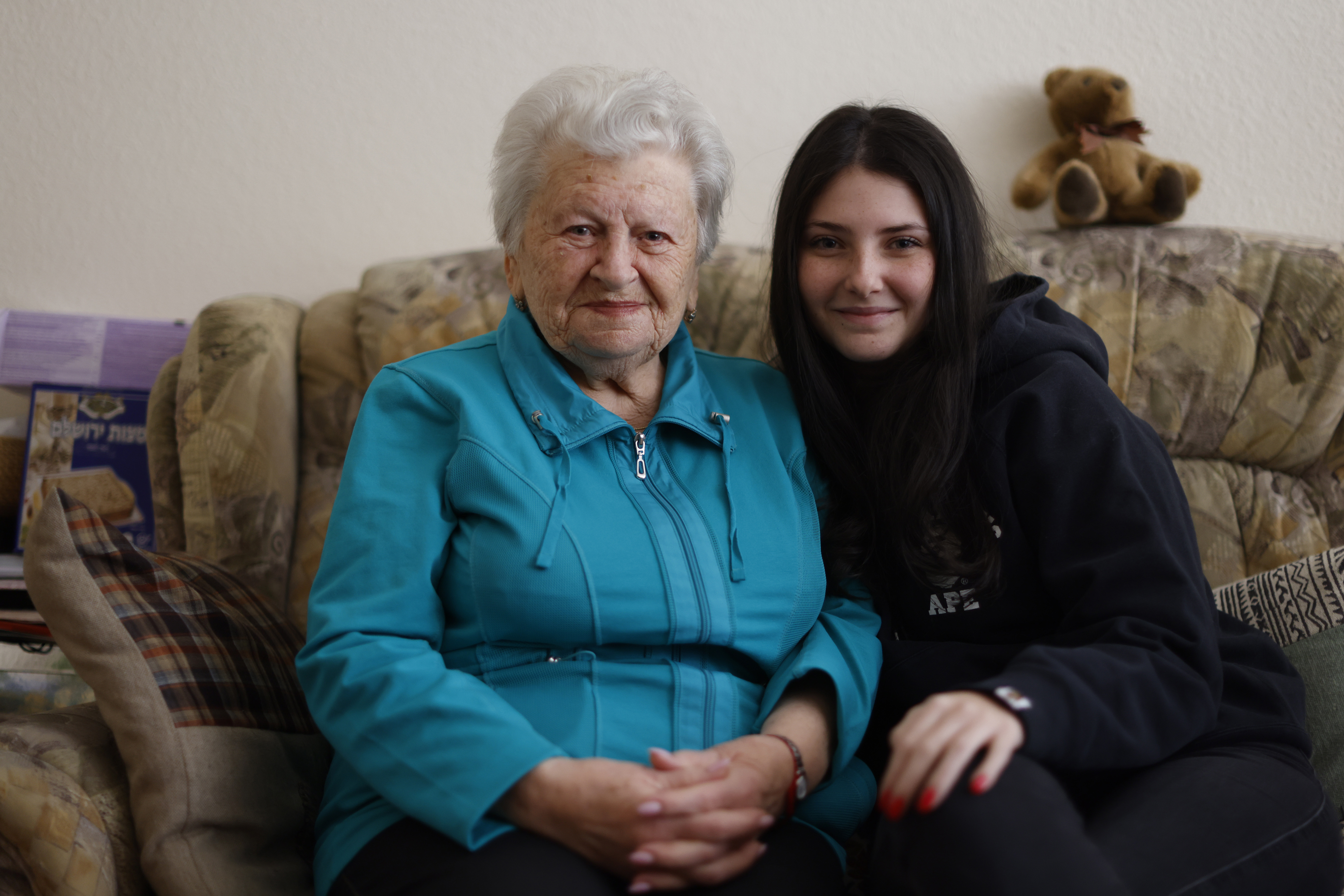 Holocaust survivor Assia Gorban, left, and her granddaughter Ruth Gorban pose during an interview with The Associated Press in Berlin, Germany, Monday, April 3, 2023. Assia Gorman and her granddaughter, 19-year-old Ruth Gorban, are taking part in the new digital campaign Our Holocaust Story: A Pledge to Remember. The campaign launched by the New York-based Conference on Jewish Material Claims Against Germany, also referred to as the Claims Conference, features survivors and their descendants from around the world and illustrates the importance of passing on the testimonies of Holocaust survivors to younger family members as the number of survivors dwindles. (AP Photo/Michele Tantussi)