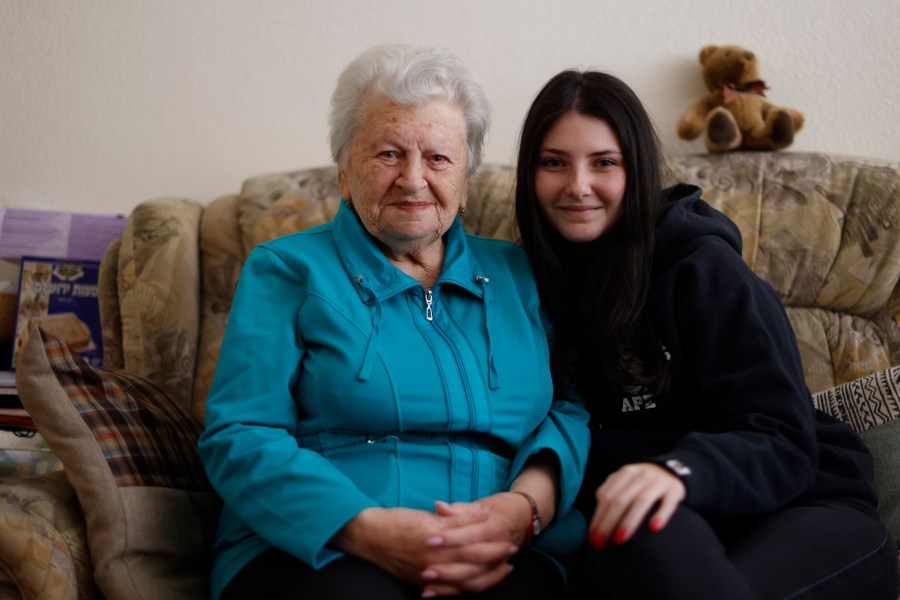 Holocaust survivor Assia Gorban, left, and her granddaughter Ruth Gorban pose during an interview with The Associated Press in Berlin, Germany, Monday, April 3, 2023. Assia Gorman and her granddaughter, 19-year-old Ruth Gorban, are taking part in the new digital campaign Our Holocaust Story: A Pledge to Remember. The campaign launched by the New York-based Conference on Jewish Material Claims Against Germany, also referred to as the Claims Conference, features survivors and their descendants from around the world and illustrates the importance of passing on the testimonies of Holocaust survivors to younger family members as the number of survivors dwindles. (AP Photo/Michele Tantussi)