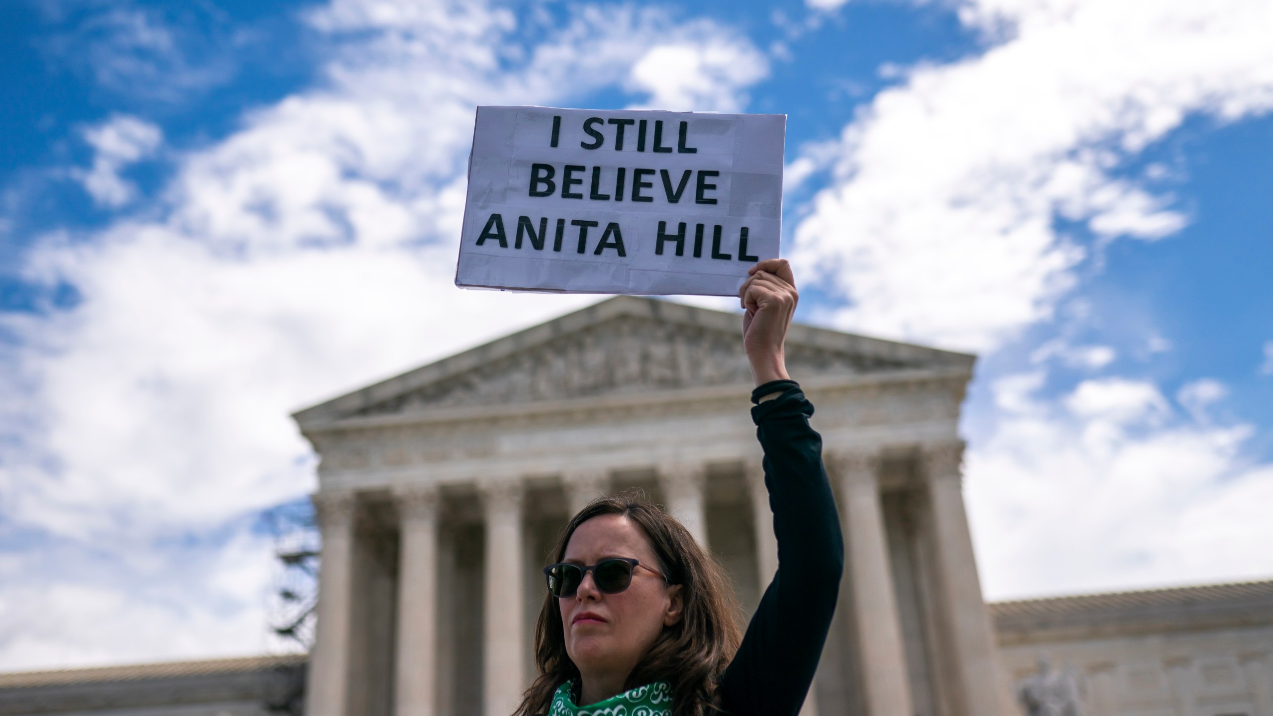 A protester holds a sign reading "I still believe Anita Hill" during a Planned Parenthood rally in support of abortion access outside the Supreme Court on Saturday, April. 15, 2023, in Washington. (AP Photo/Nathan Howard)