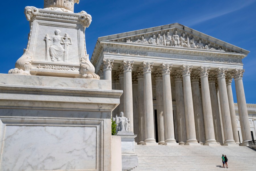 FILE - The Supreme Court is seen, with a carving of Justice in the foreground, April 19, 2023, in Washington. The Supreme Court is facing a self-imposed Friday night deadline to decide whether women’s access to a widely used abortion pill will stay unchanged until a legal challenge to its Food and Drug Administration approval is resolved. (AP Photo/Jacquelyn Martin, File)