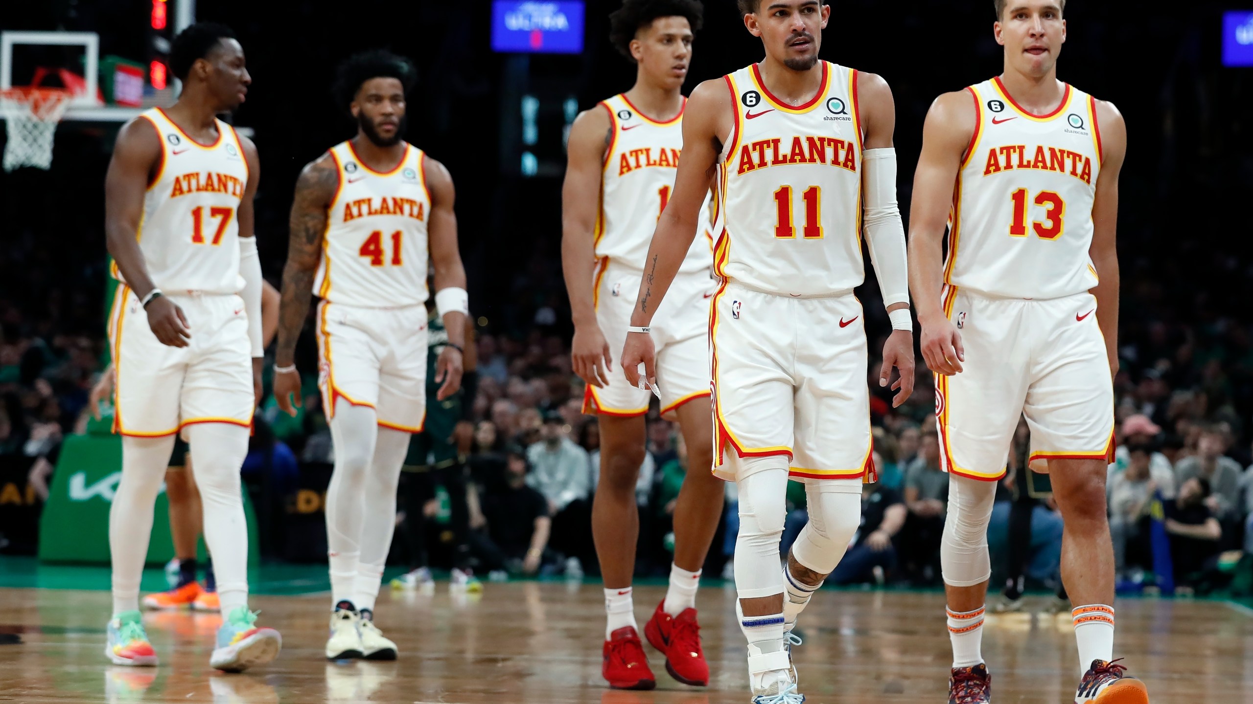 Atlanta Hawks players, from left, Onyeka Okongwu, Saddiq Bey, Jalen Johnson, Trae Young and Bogdan Bogdanovic walk to the bench at the end of the third quarter in Game 1 in the first round of the NBA basketball playoffs, Saturday, April 15, 2023, in Boston. (AP Photo/Michael Dwyer)