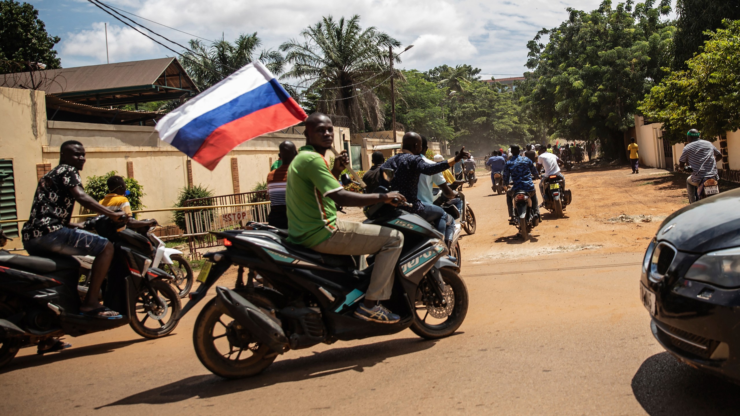 FILE - Supporters of Capt. Ibrahim Traore parade wave a Russian flag in the streets of Ouagadougou, Burkina Faso, Oct. 2, 2022. Just weeks after Burkina Faso's junta ousted hundreds of French troops, there are signs that the West African country could be moving even closer to Russia, including the mercenary outfit, the Wagner Group. (AP Photo/Sophie Garcia, File)