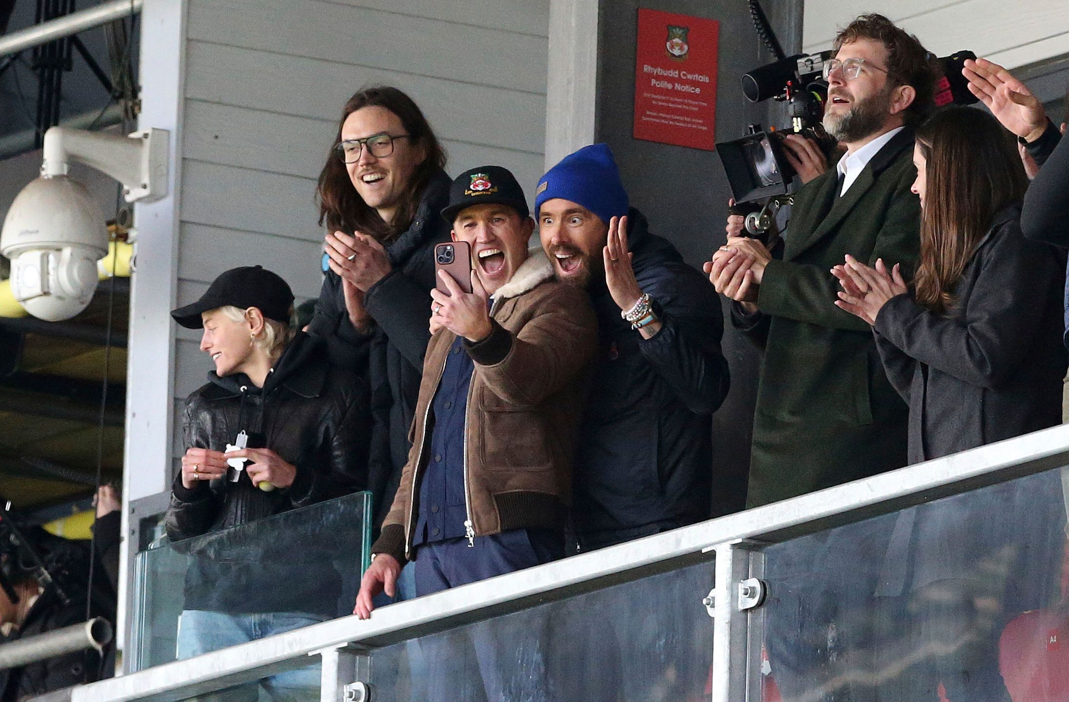 FILE - Wrexham owners Ryan Reynolds, center right, and Rob McElhenney, center left, react during the National League match between Wrexham and Notts County at the Racecourse Ground, Wrexham, Wales, Monday April 10, 2023. It's hard to imagine that even A-list owners Ryan Reynolds and Rob McElhenney anticipated the unscripted drama created by this unlikely union between Tinseltown and Wrexham, a former mining town in Wales. (Barrington Coombs/PA via AP, File)