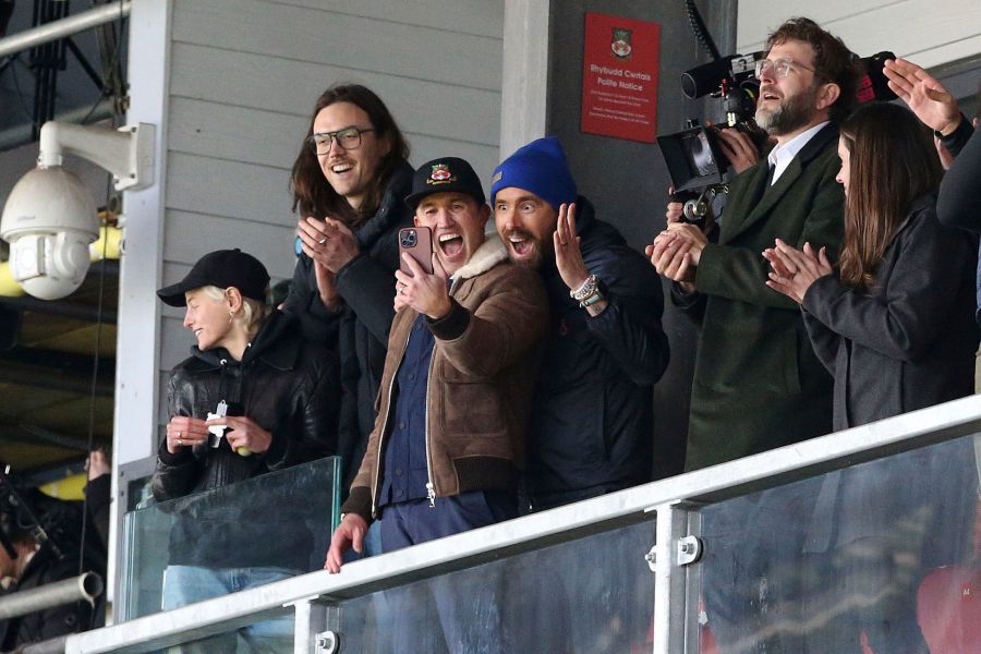 FILE - Wrexham owners Ryan Reynolds, center right, and Rob McElhenney, center left, react during the National League match between Wrexham and Notts County at the Racecourse Ground, Wrexham, Wales, Monday April 10, 2023. It's hard to imagine that even A-list owners Ryan Reynolds and Rob McElhenney anticipated the unscripted drama created by this unlikely union between Tinseltown and Wrexham, a former mining town in Wales. (Barrington Coombs/PA via AP, File)