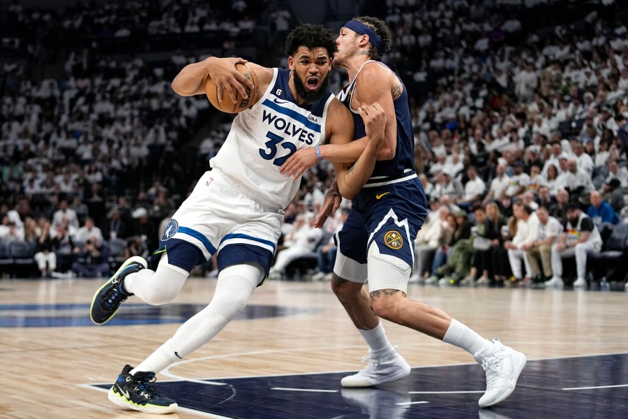 Minnesota Timberwolves center Karl-Anthony Towns (32) works toward the basket while defended by Denver Nuggets forward Aaron Gordon (50) during the second half of Game 4 of an NBA basketball first-round playoff series Sunday, April 23, 2023, in Minneapolis. (AP Photo/Abbie Parr)