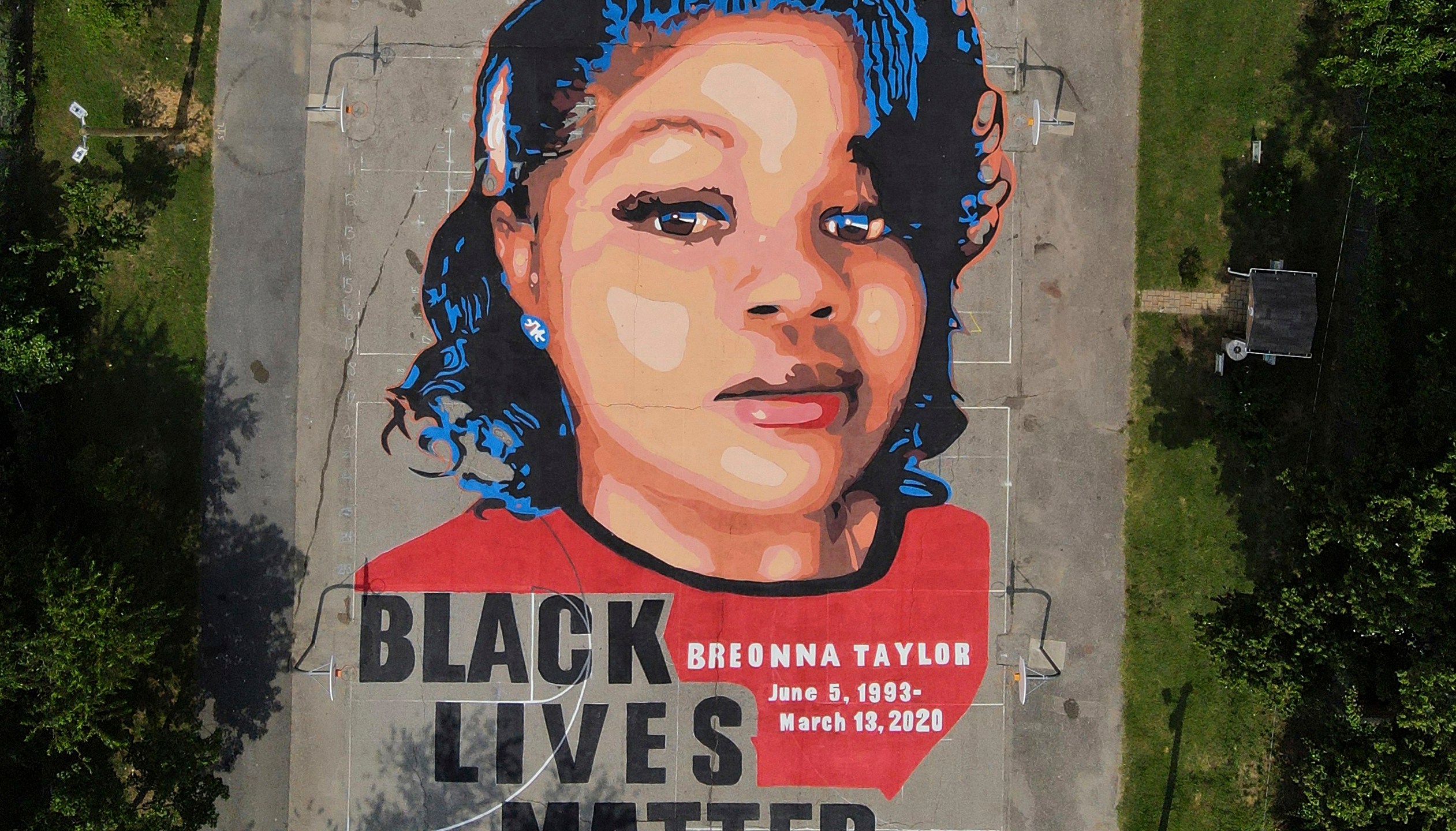 FILE - A ground mural depicting a portrait of Breonna Taylor is seen at Chambers Park in Annapolis, Md., July 6, 2020. The former Louisville Metro Police officer who fatally shot Breonna Taylor has a new job in law enforcement. WHAS-TV reported that the Carroll County Sheriff’s Office confirmed Saturday, April 24, 2023, the hiring of Myles Cosgrove who was fired from the police department in January 2021 for violating use-of-force procedures and failing to use a body camera during the raid on Taylor’s apartment. (AP Photo/Julio Cortez, File)