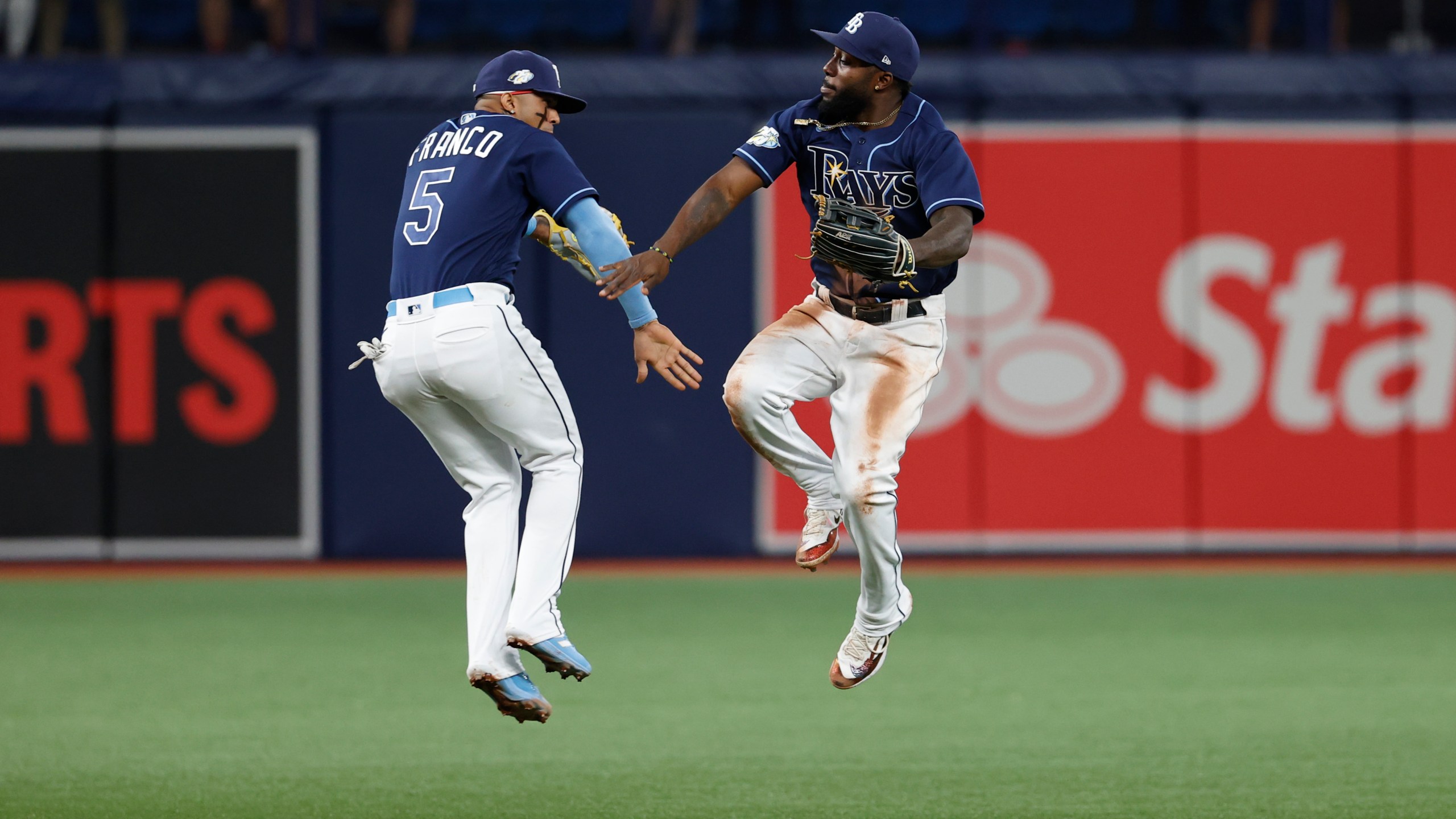 Tampa Bay Rays' Wander Franco, left, and Randy Arozarena celebrate after the Rays defeated the Boston Red Sox in a baseball game Tuesday, April 11, 2023, in St. Petersburg, Fla. (AP Photo/Scott Audette)