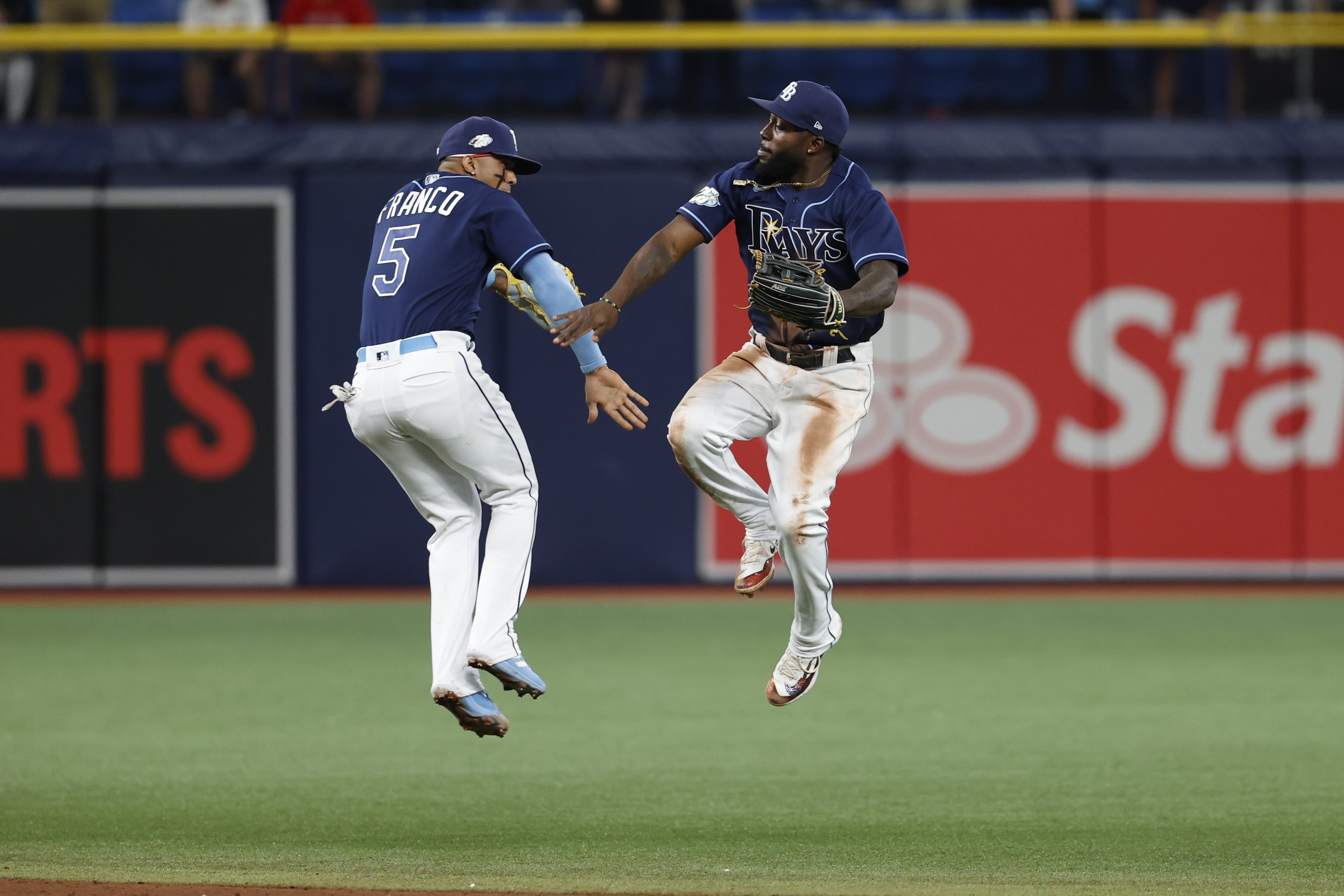 Tampa Bay Rays' Wander Franco, left, and Randy Arozarena celebrate after the Rays defeated the Boston Red Sox in a baseball game Tuesday, April 11, 2023, in St. Petersburg, Fla. (AP Photo/Scott Audette)