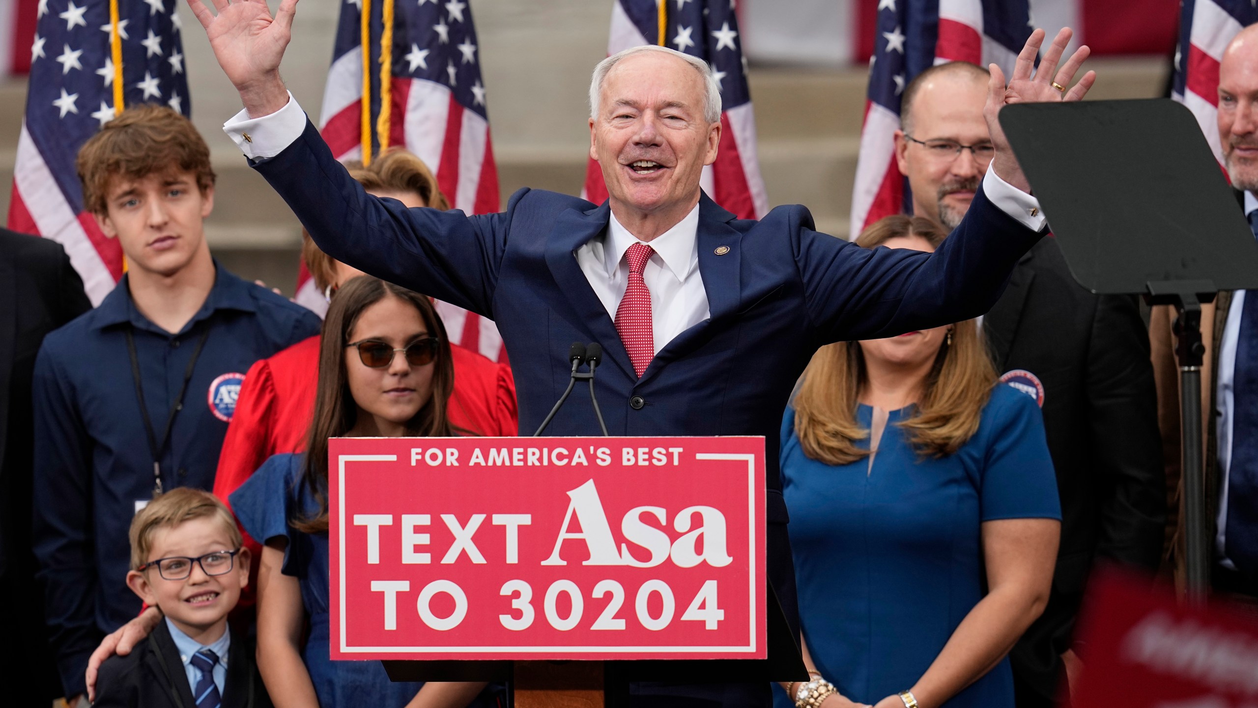 Former Arkansas Gov. Asa Hutchinson is surrounded by family members after formally announcing his Republican campaign for president, Wednesday, April 26, 2023, in Bentonville, Ark. (AP Photo/Sue Ogrocki)