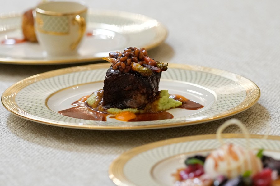 Dishes are displayed during a media preview, Monday, April 24, 2023, in advance of Wednesday's State Dinner with South Korea's President Yoon Suk Yeol at the White House in Washington. The dish in the center is a braised beef short rib with butter bean grits, sorghum-glazed carrots and pine nuts. (AP Photo/Susan Walsh)