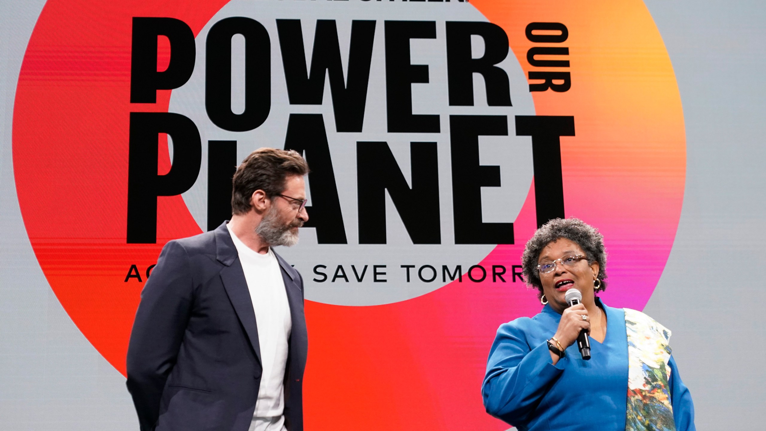 Actor Hugh Jackman, left, is joined by Prime Minister of Barbados Mia Mottley onstage at the Global Citizen NOW Summit, Thursday, April 27, 2023, in New York. (AP Photo/Mary Altaffer)