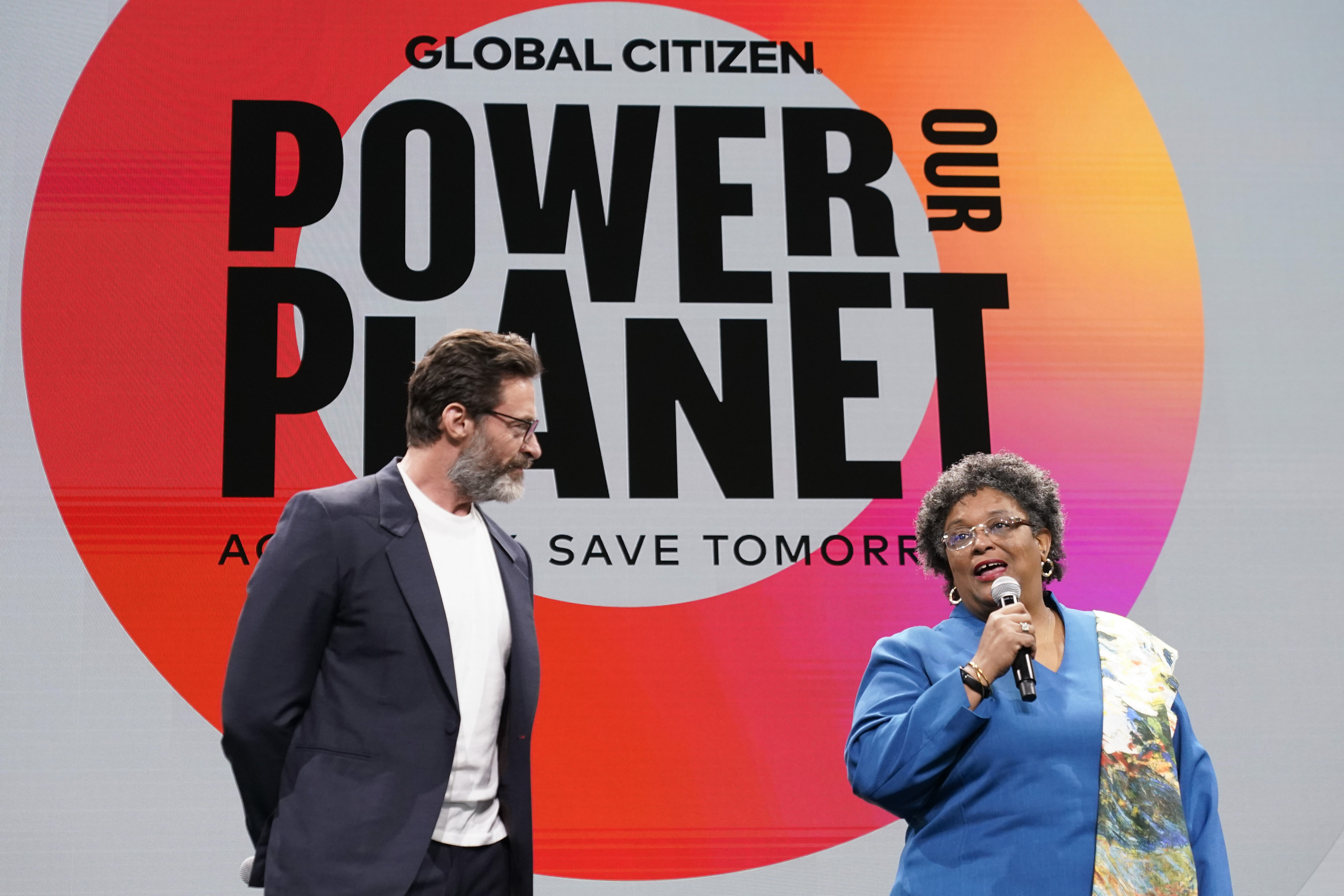 Actor Hugh Jackman, left, is joined by Prime Minister of Barbados Mia Mottley onstage at the Global Citizen NOW Summit, Thursday, April 27, 2023, in New York. (AP Photo/Mary Altaffer)