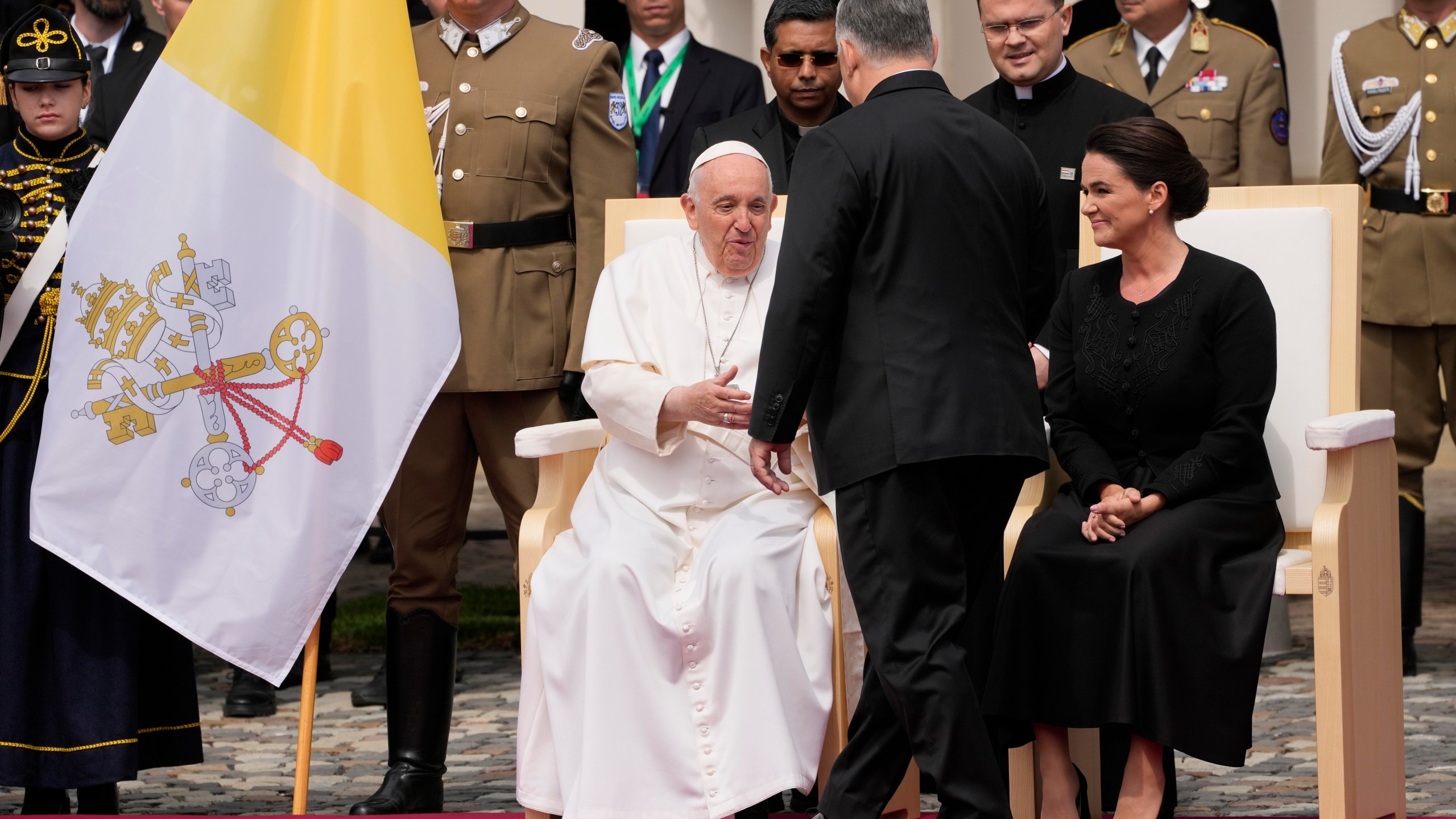 Pope Francis, left, is greeted by Hungary Prime Minister Viktor Orban in the square of "Sándor" Palace in Budapest, Friday, April 28, 2023. The Pontiff is in Hungary for a three-day pastoral visit. (AP Photo/Andrew Medichini)