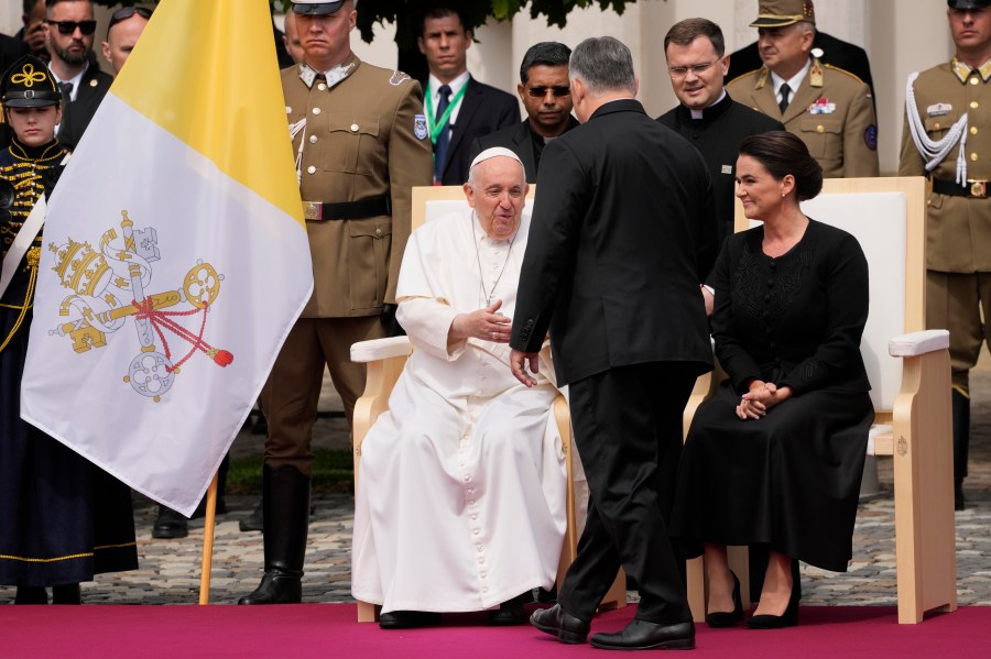 Pope Francis, left, is greeted by Hungary Prime Minister Viktor Orban in the square of "Sándor" Palace in Budapest, Friday, April 28, 2023. The Pontiff is in Hungary for a three-day pastoral visit. (AP Photo/Andrew Medichini)